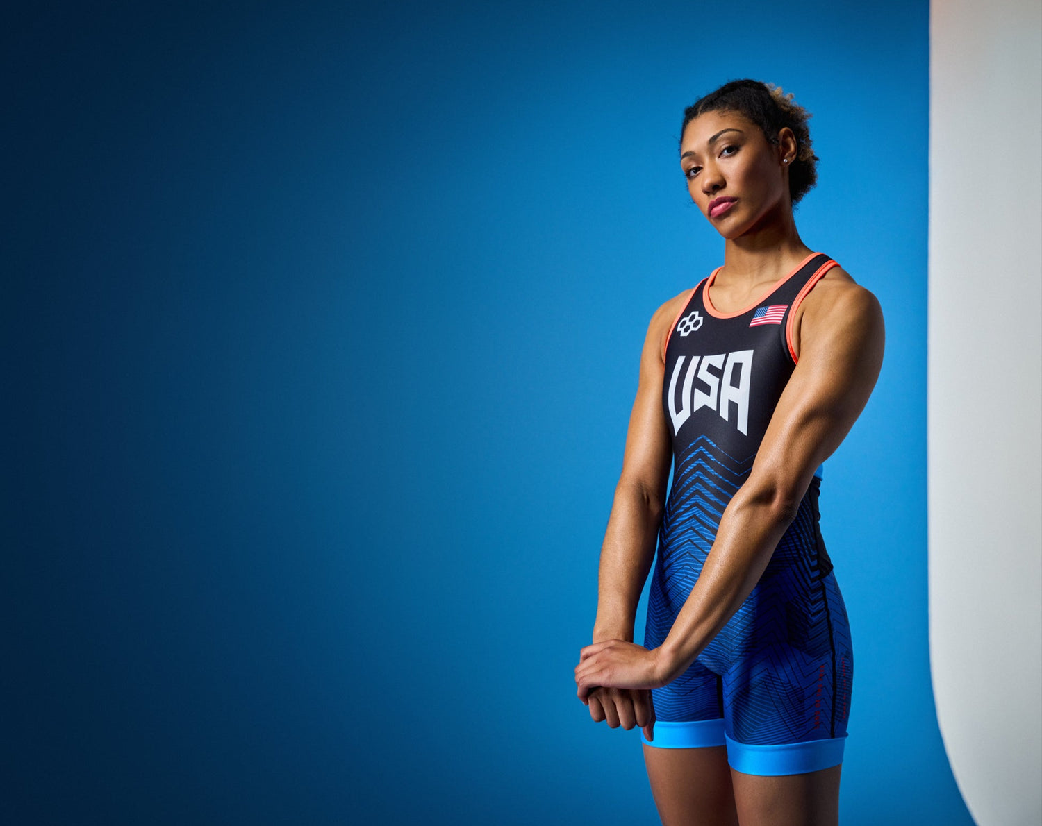 Kennedy Blades wrestler wearing a USA Wrestling RUDIS Wrestling Singlet against a blue background
