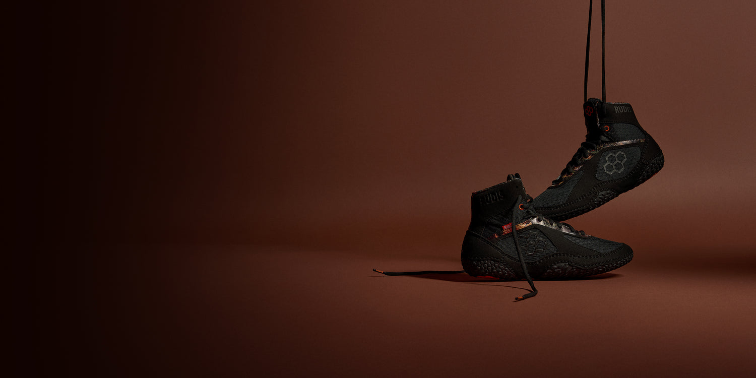 RUDIS Alpha 2.0 wrestling shoes in Terrain colorway suspended in studio showcasing lightweight build, durability, and mat-ready traction