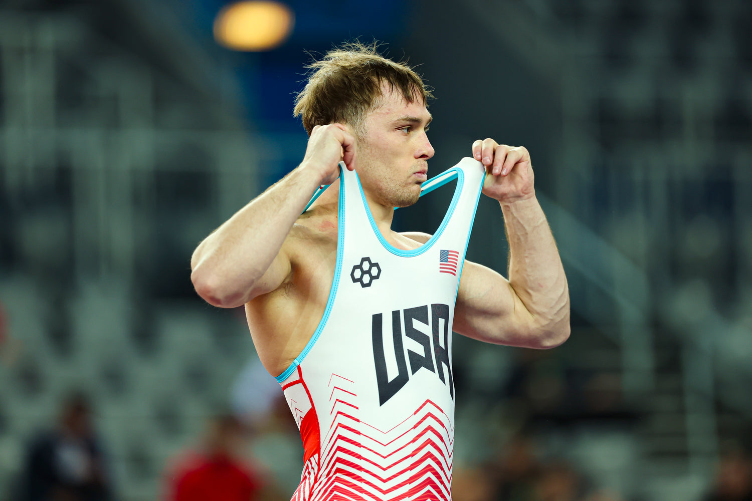 Spencer Lee wearing USA Wrestling RUDIS Wrestling Singlet with a blurred background