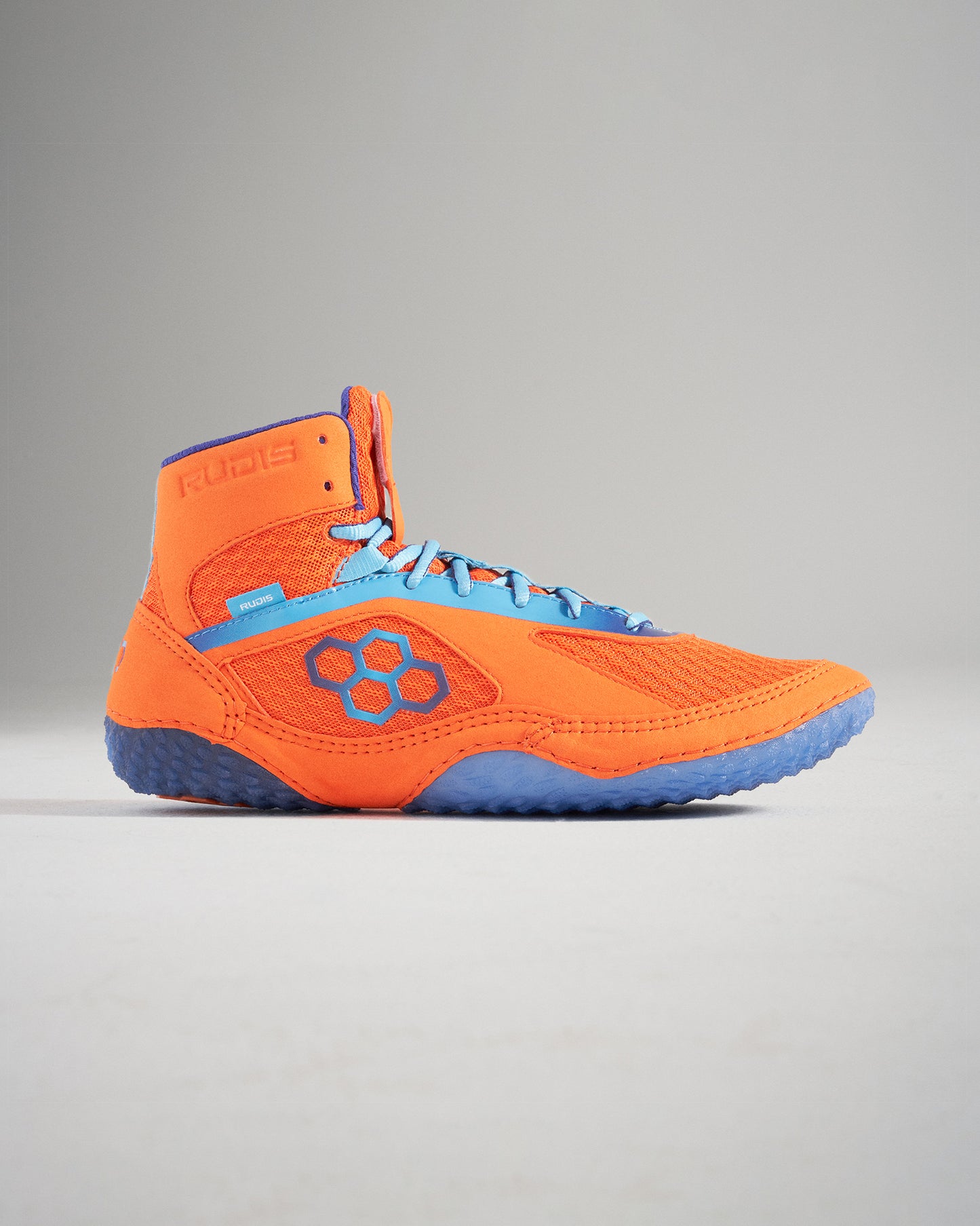 A vibrant pair of orange wrestling shoes featuring a breathable mesh design and blue accents optimized for performance and grip