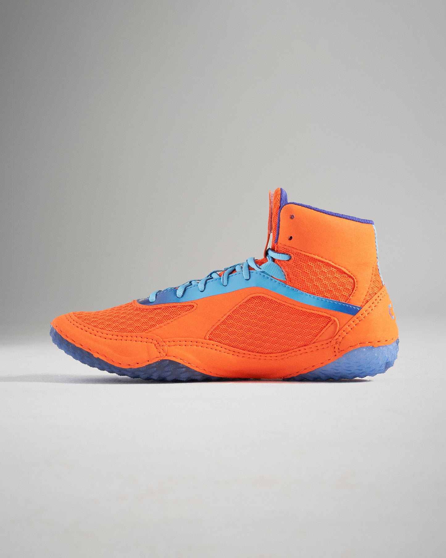 A vibrant orange and blue high-top athletic shoe designed for performance featuring a breathable mesh upper and durable rubber sole