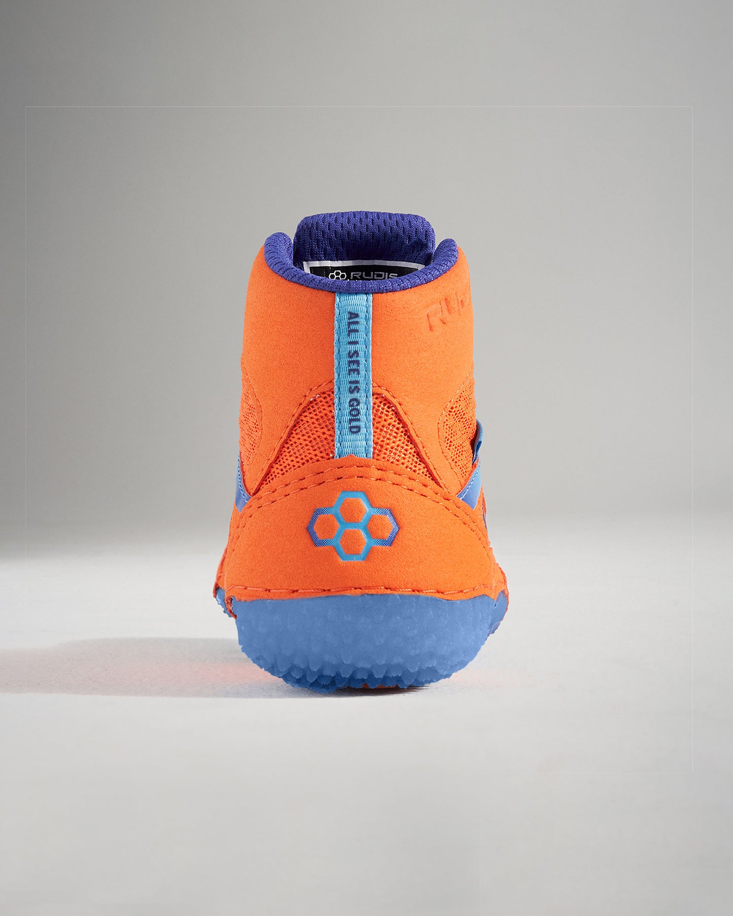 A rear view of a vibrant orange athletic shoe featuring a textured blue sole and mesh detailing for breathability and support
