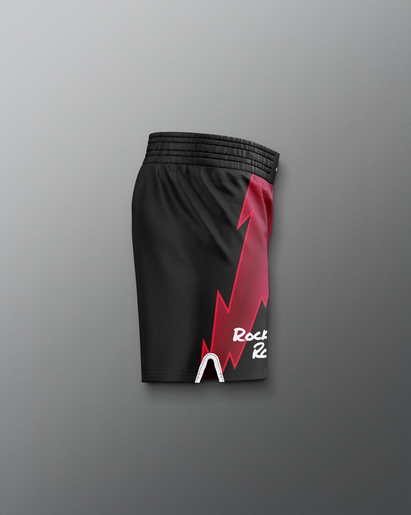 Black shorts with a red lightning bolt design on a gray background