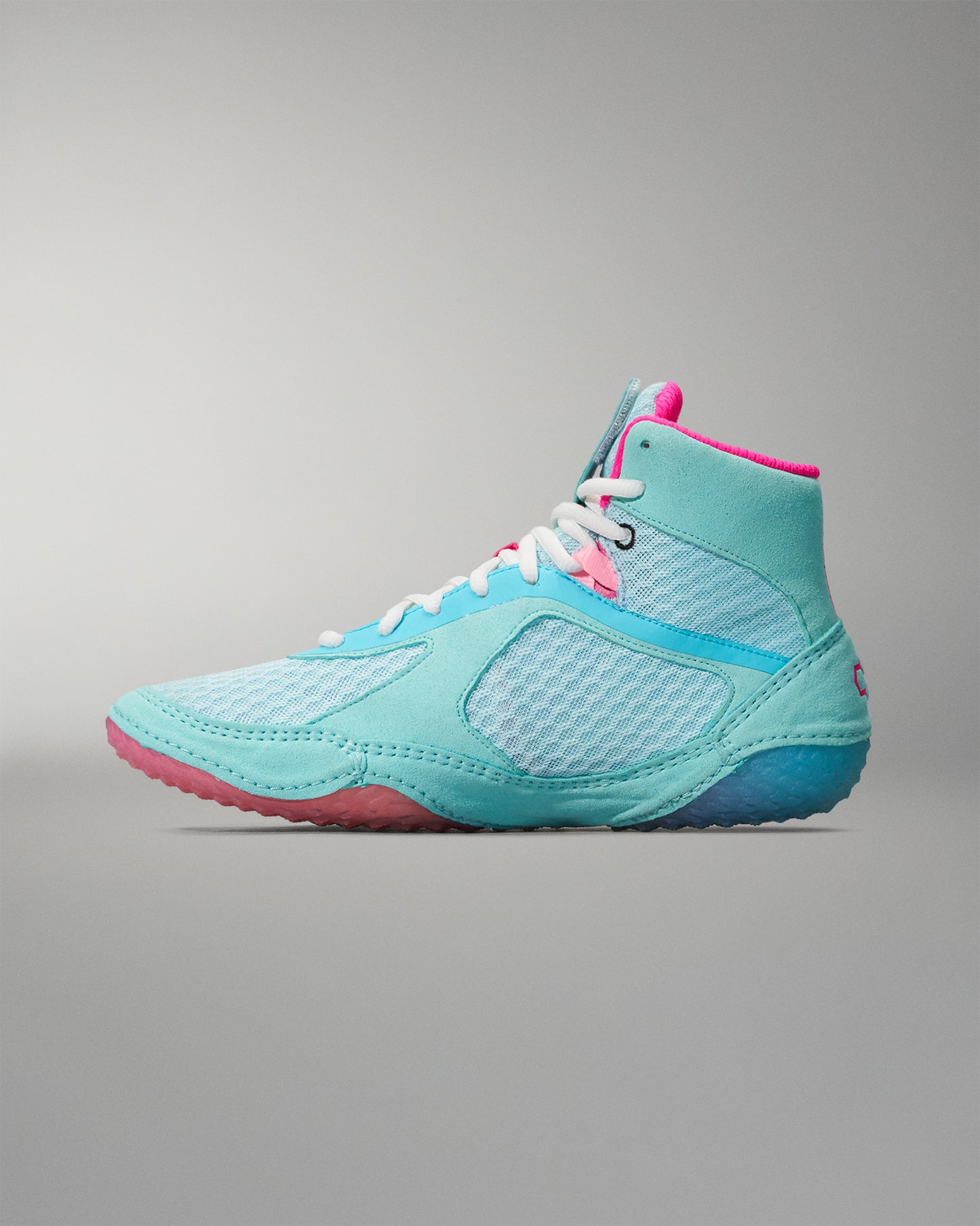 Turquoise and pink Wrestling Shoe on a gray background