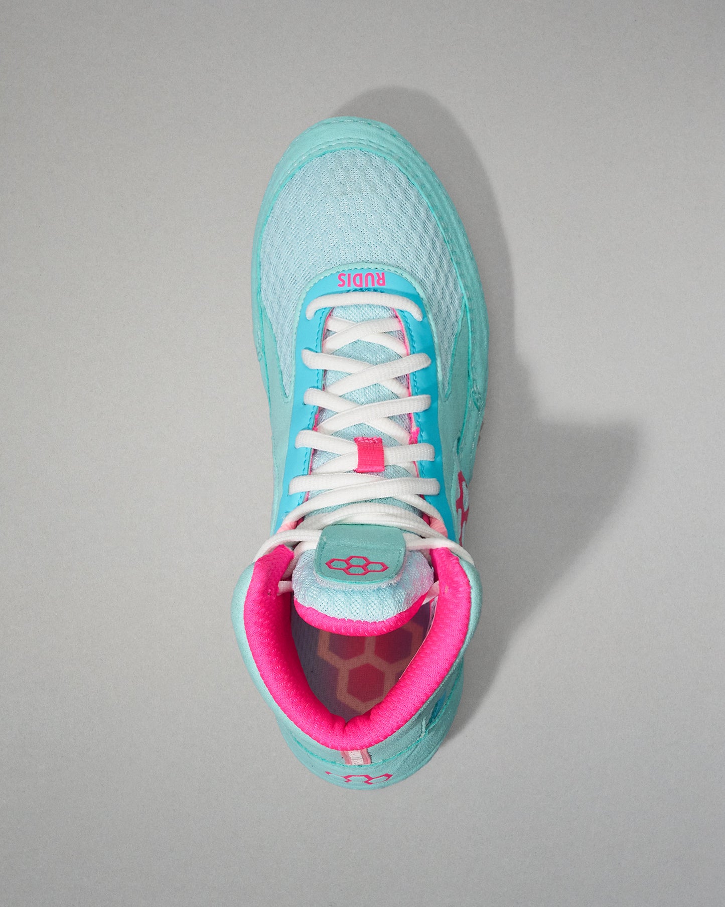 Turquoise Wrestling Shoe with pink interior on a gray background