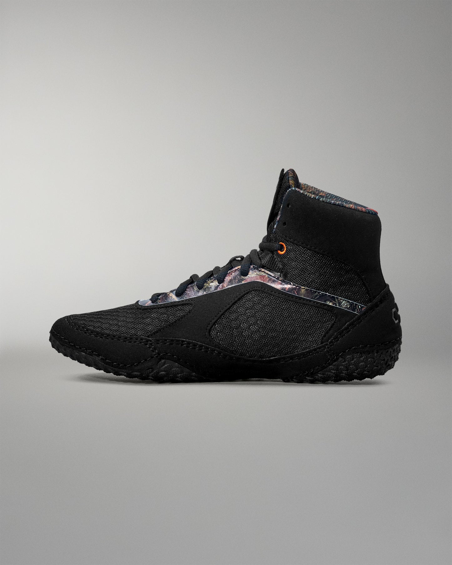 Black wrestling shoe on a gray background