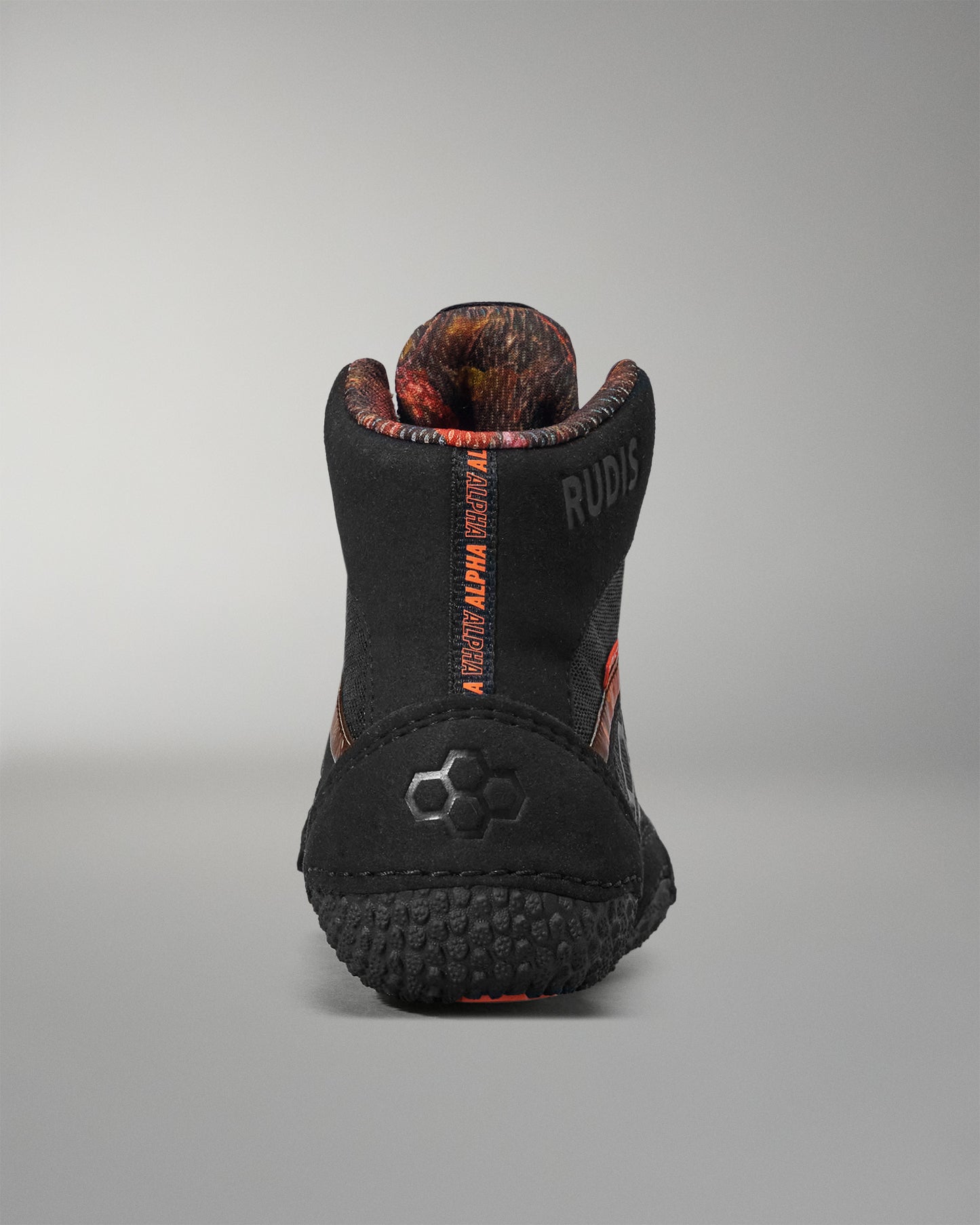 Black and orange boot with visible branding on a gray background