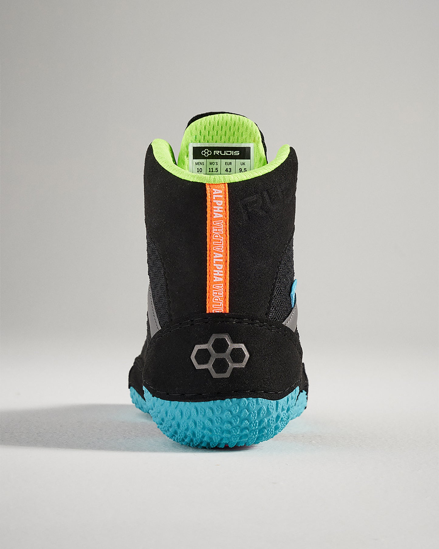 A back view of a black athletic shoe featuring a textured blue sole bright green lining and vibrant orange branding showcasing modern design elements for optimal performance
