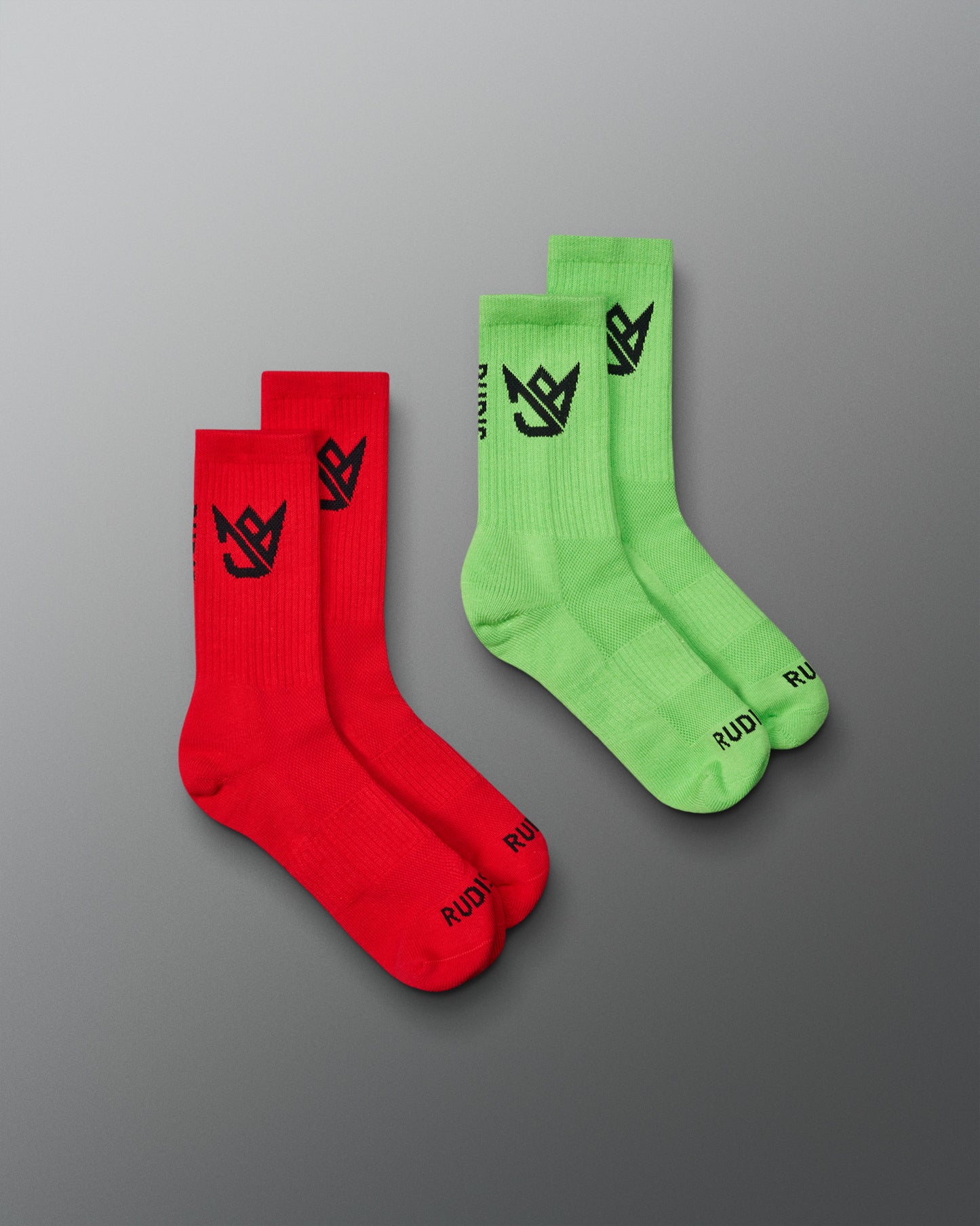 Two pairs of socks, one red and one green, on a gray background.