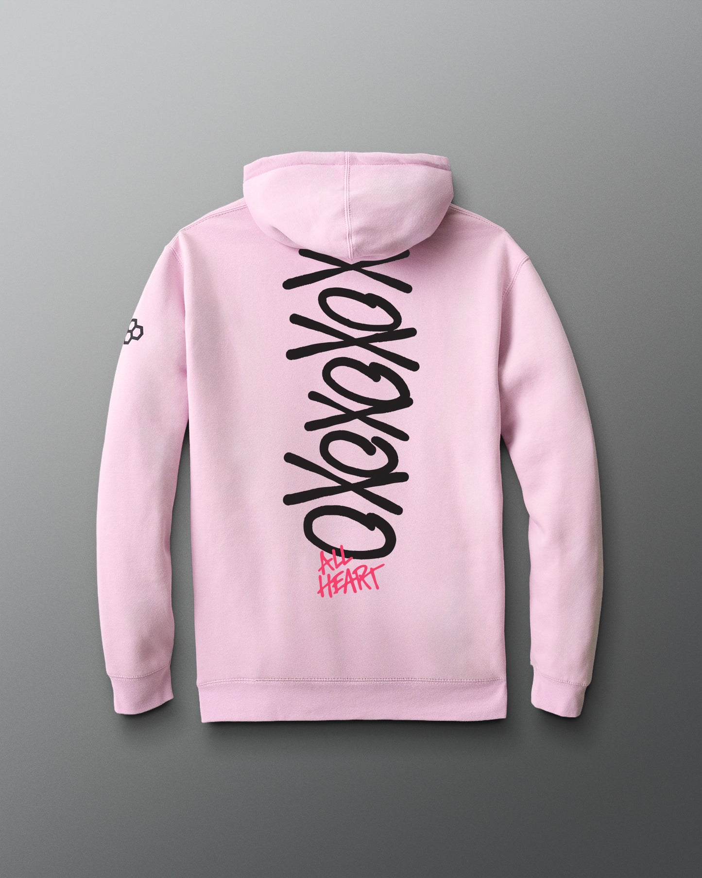 Pink hoodie with black and red text on the back against a gray background