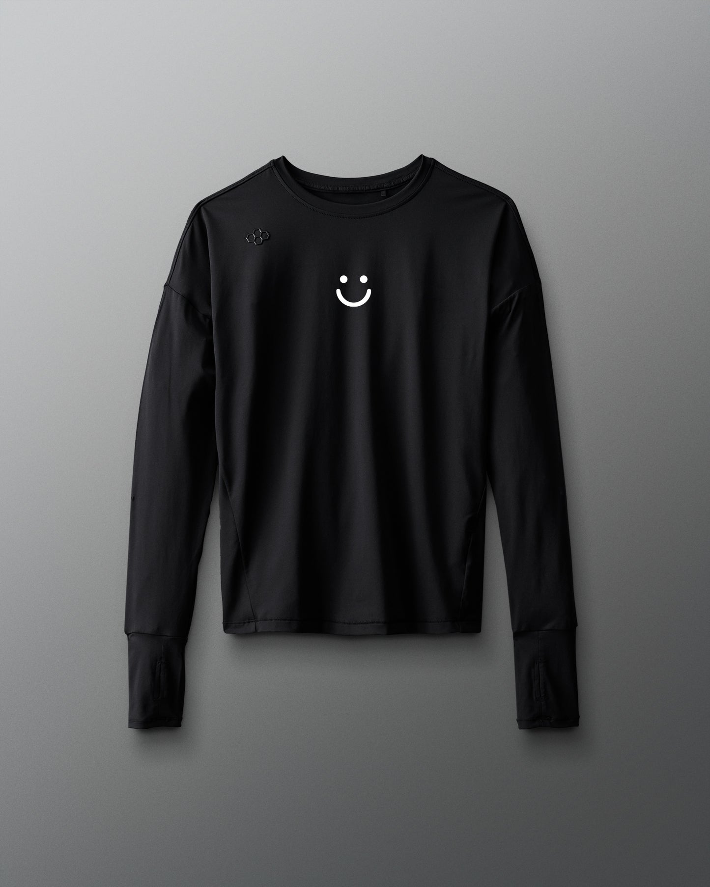 Black long-sleeve shirt with a smiley face emblem on a gray background