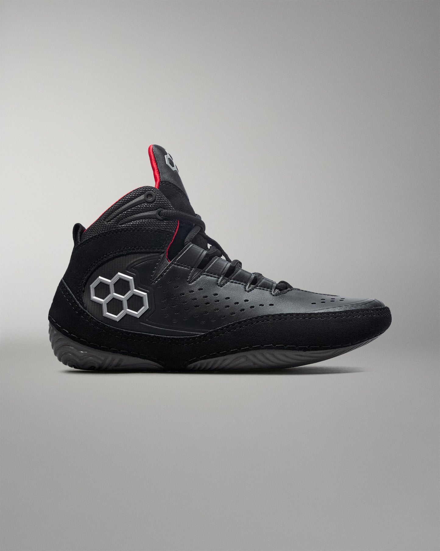 Black wrestling shoe with a unique logo on a gray background - Cary Kolat wrestling shoes