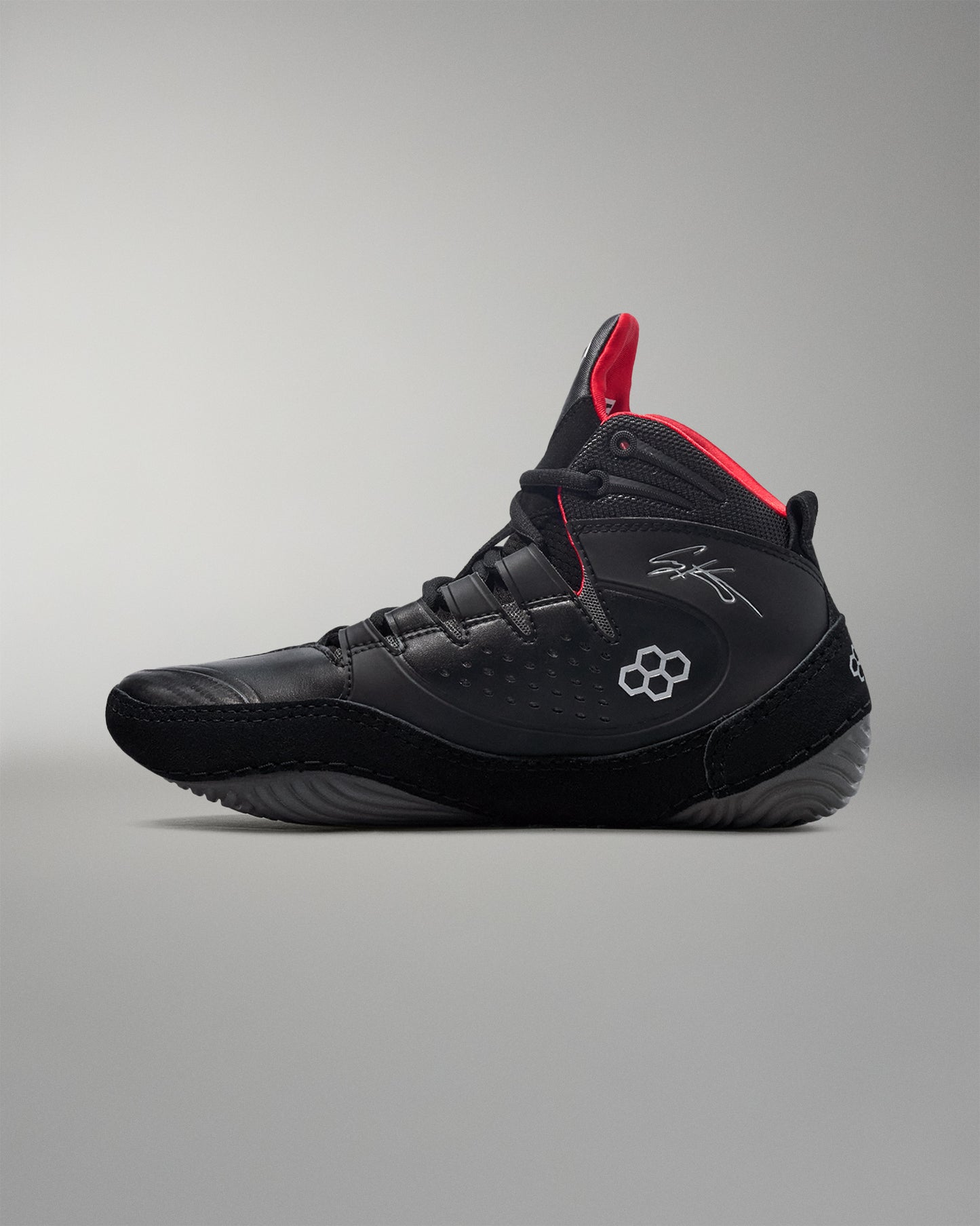 Black wrestling shoe with red accents on a gray background - Cary Kolat wrestling shoes