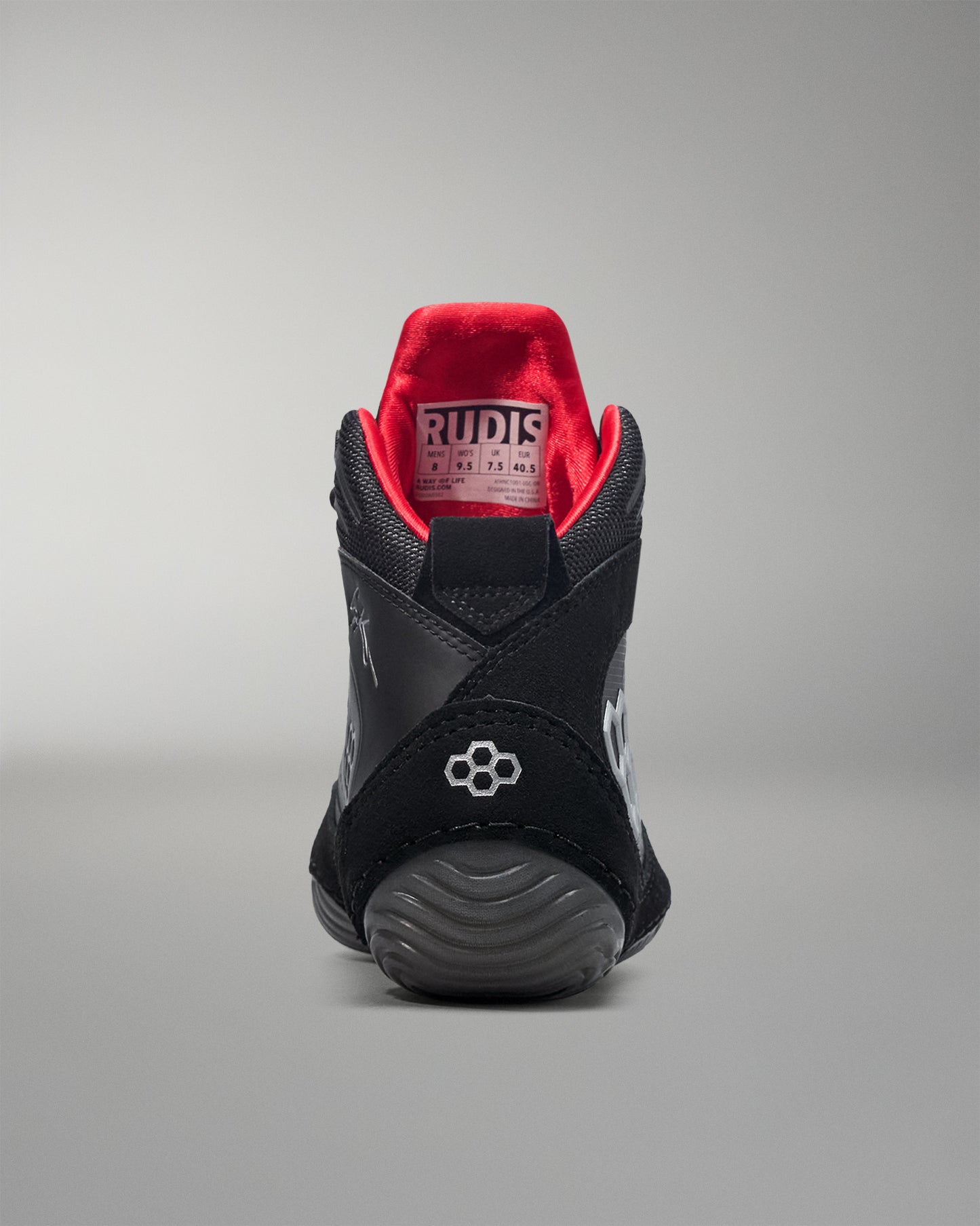 Black wrestling shoe with red interior on a gray background - Cary Kolat wrestling shoes