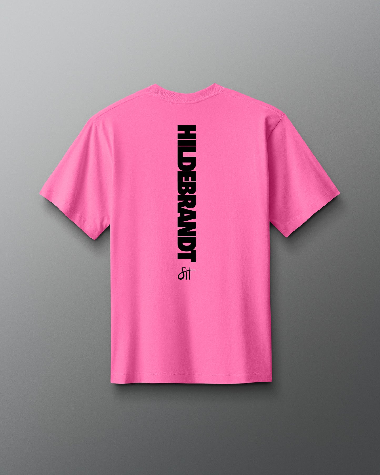 Pink t-shirt with 'HILDEBRANDT' logo on the back against a gray background
