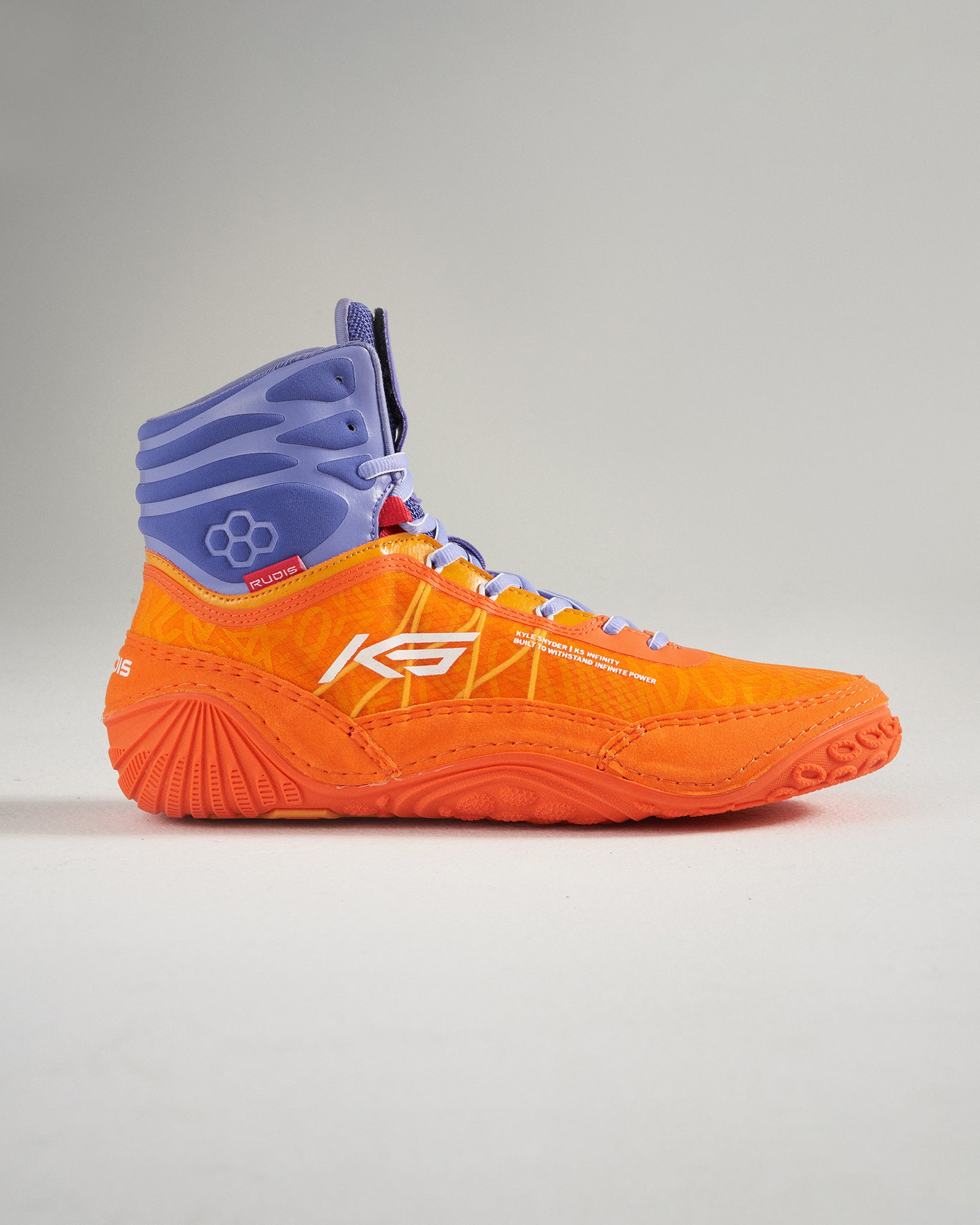 A vibrant orange wrestling shoe featuring a high-top design with purple accents and textured sole for grip showcasing a modern athletic aesthetic