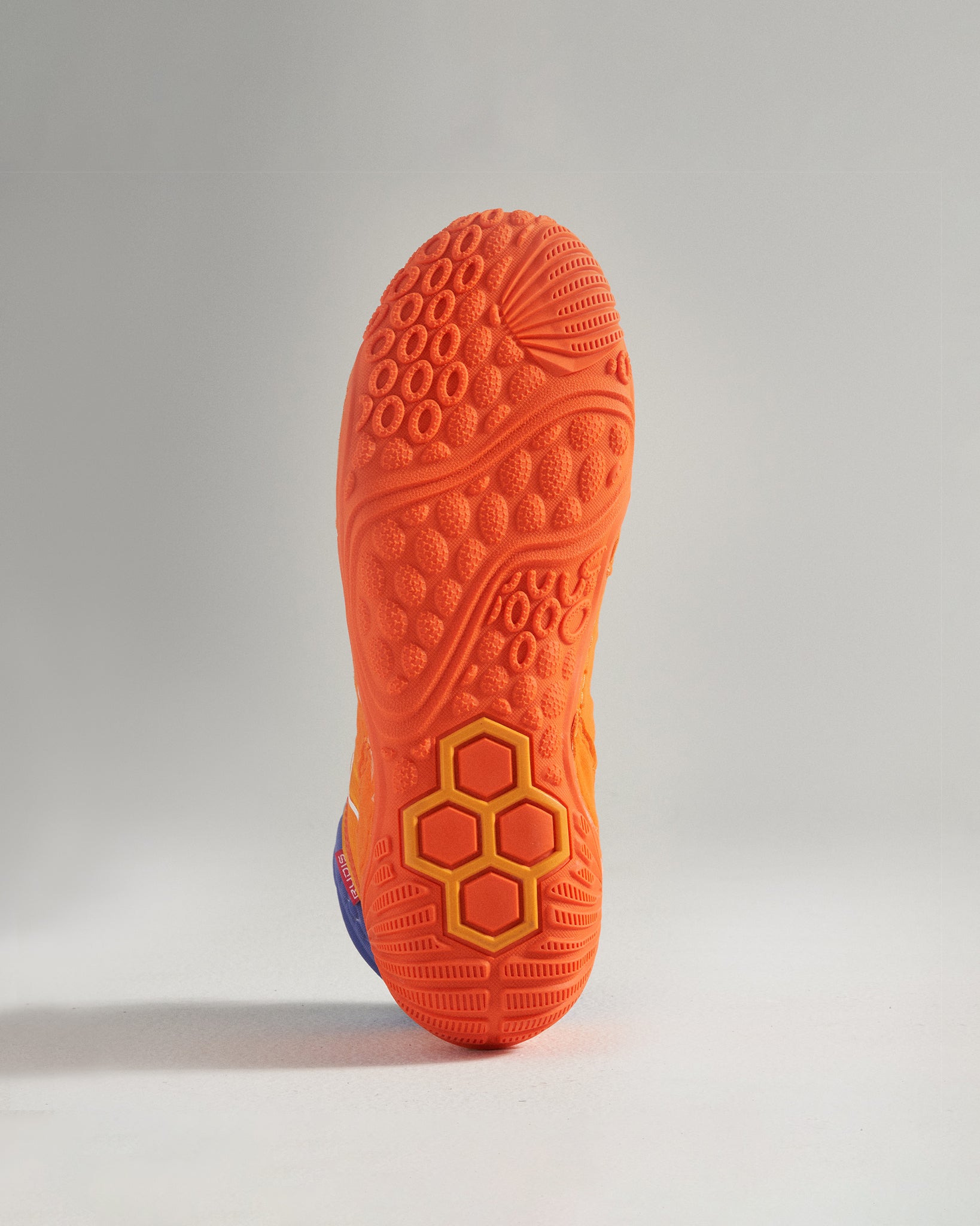 The vibrant sole of a colorful athletic shoe featuring intricate patterns designed for traction and performance