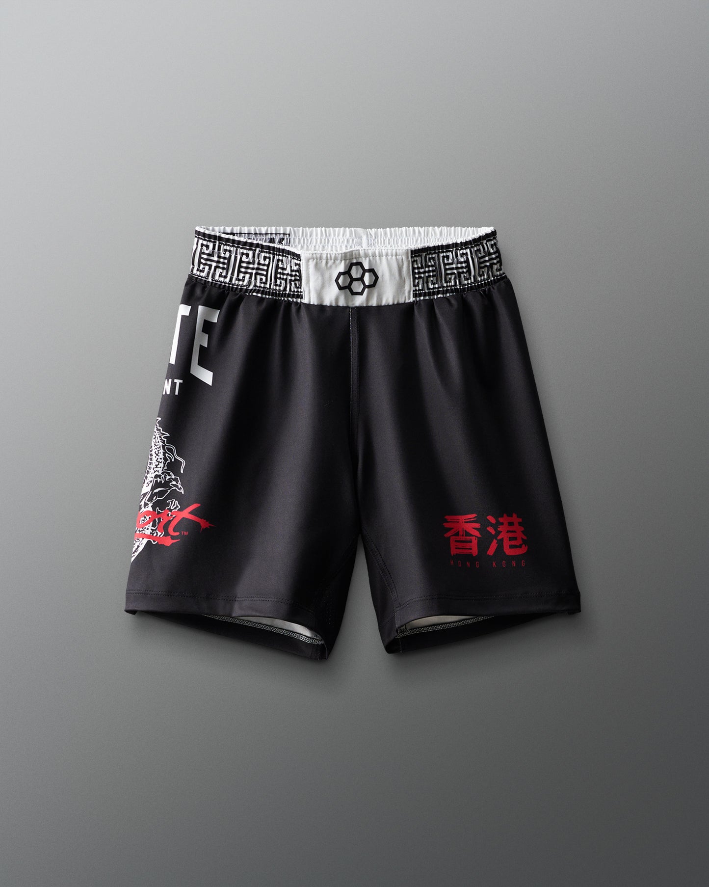 Black shorts with red text and white waistband on a gray background