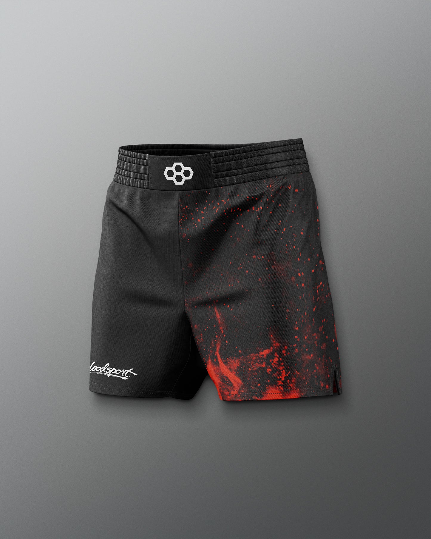 Black athletic shorts with red splatter design on a gray background