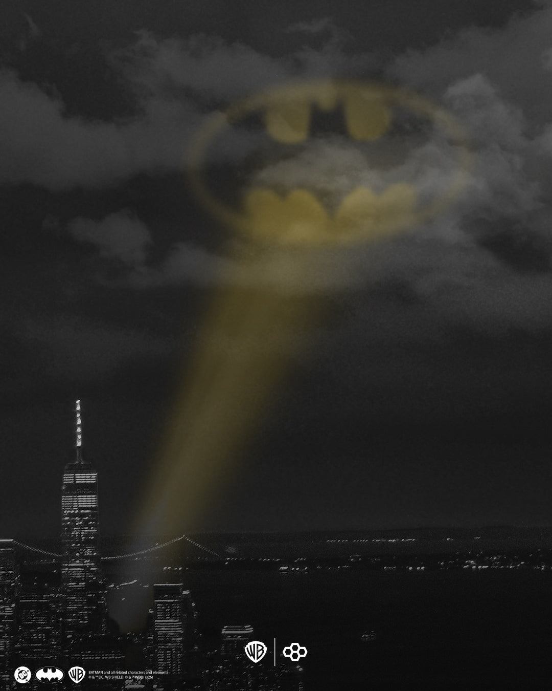Batman logo projected onto a cloudy sky with a cityscape below, featuring Warner Bros. logos.
