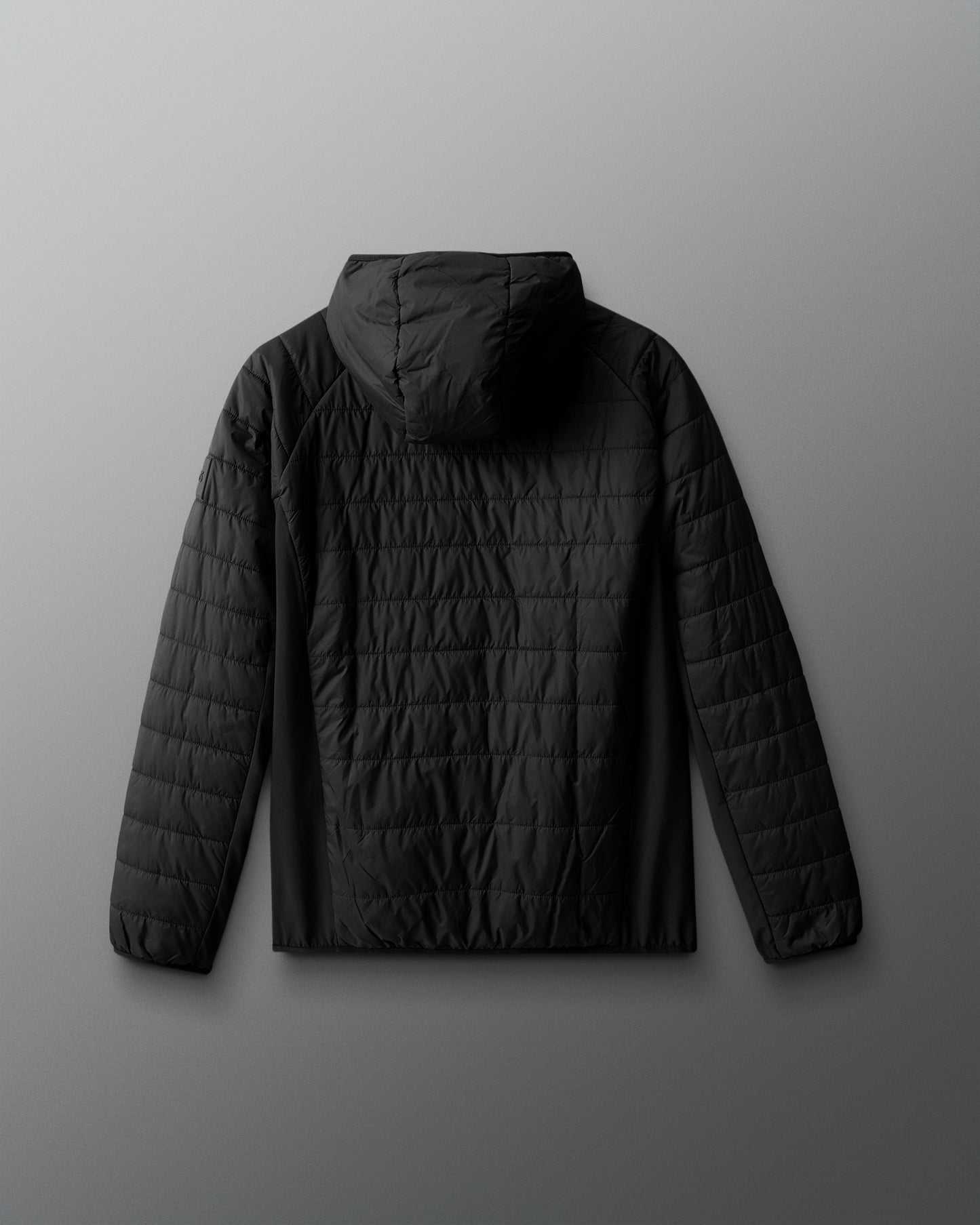 Black quilted jacket on a gray background