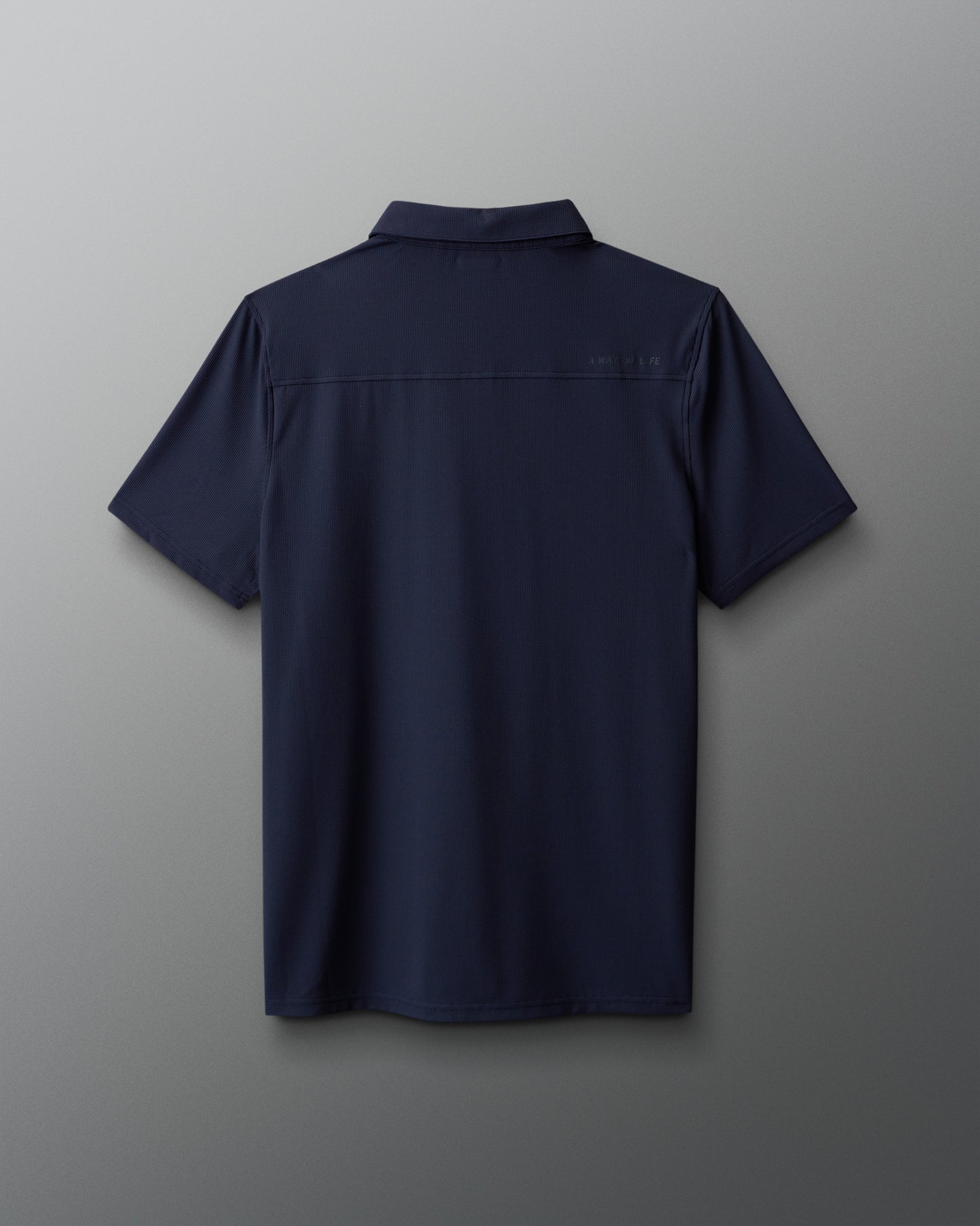 Navy blue polo shirt on a gray background
