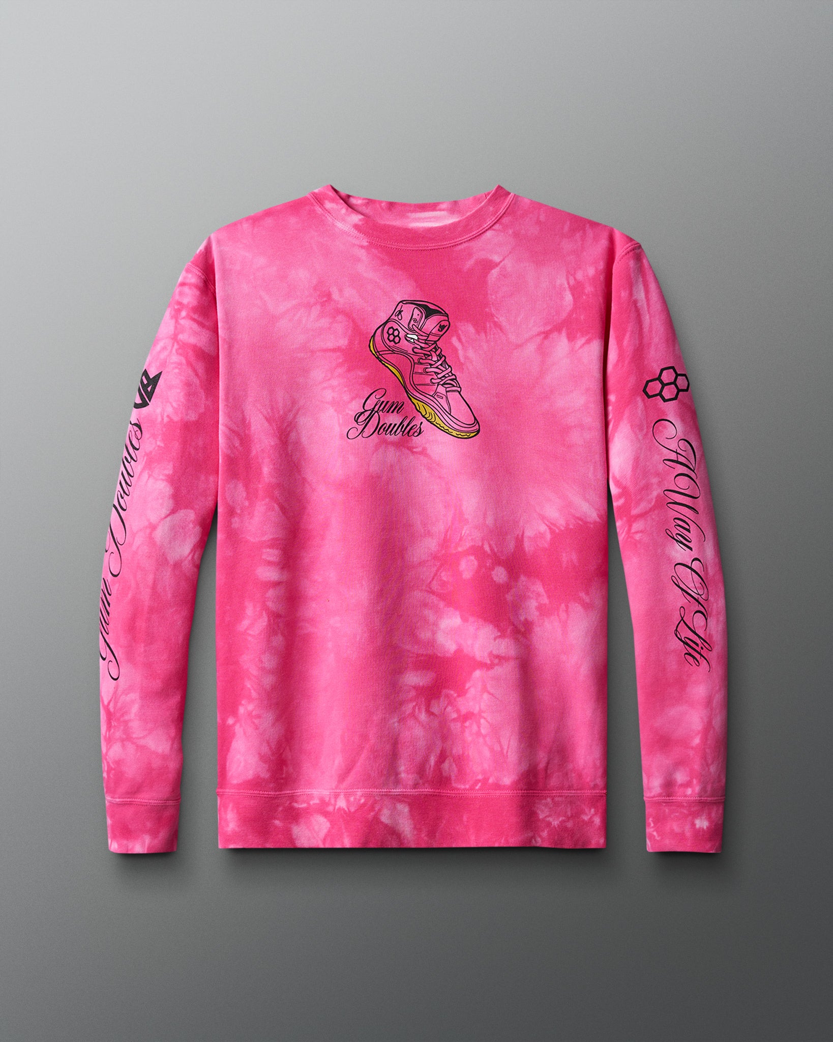A tie-dye crewneck sweatshirt in pink with a graphic of a shoe and text on the front.