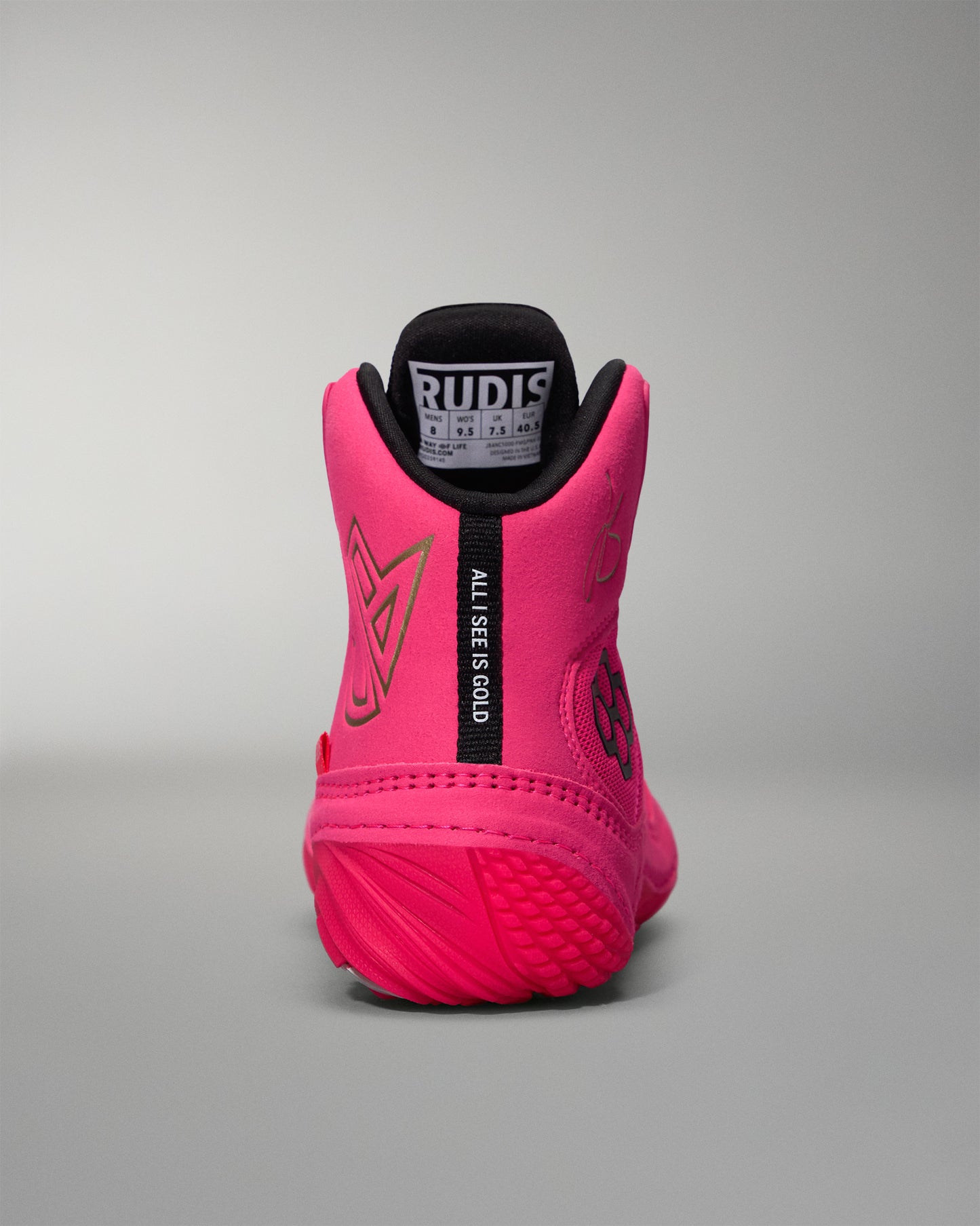 Pink wrestling shoe with black sole on a gray background