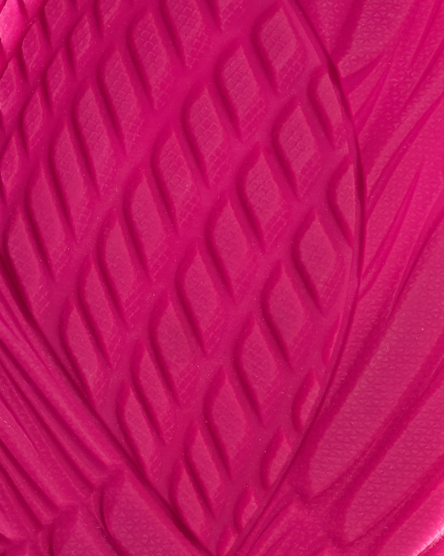 Close-up of a textured pink surface with a wavy pattern