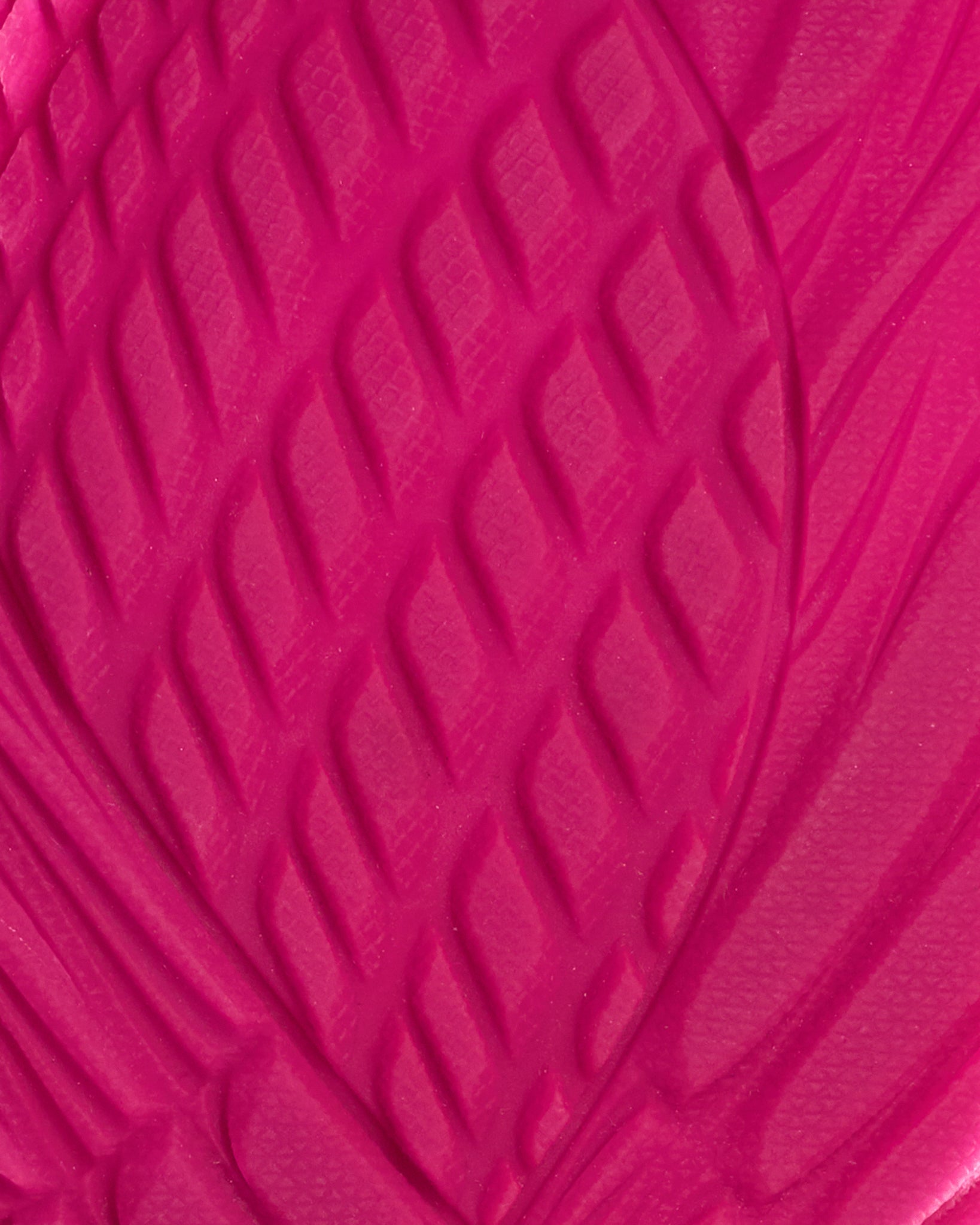 Close-up of a textured pink surface with a wavy pattern