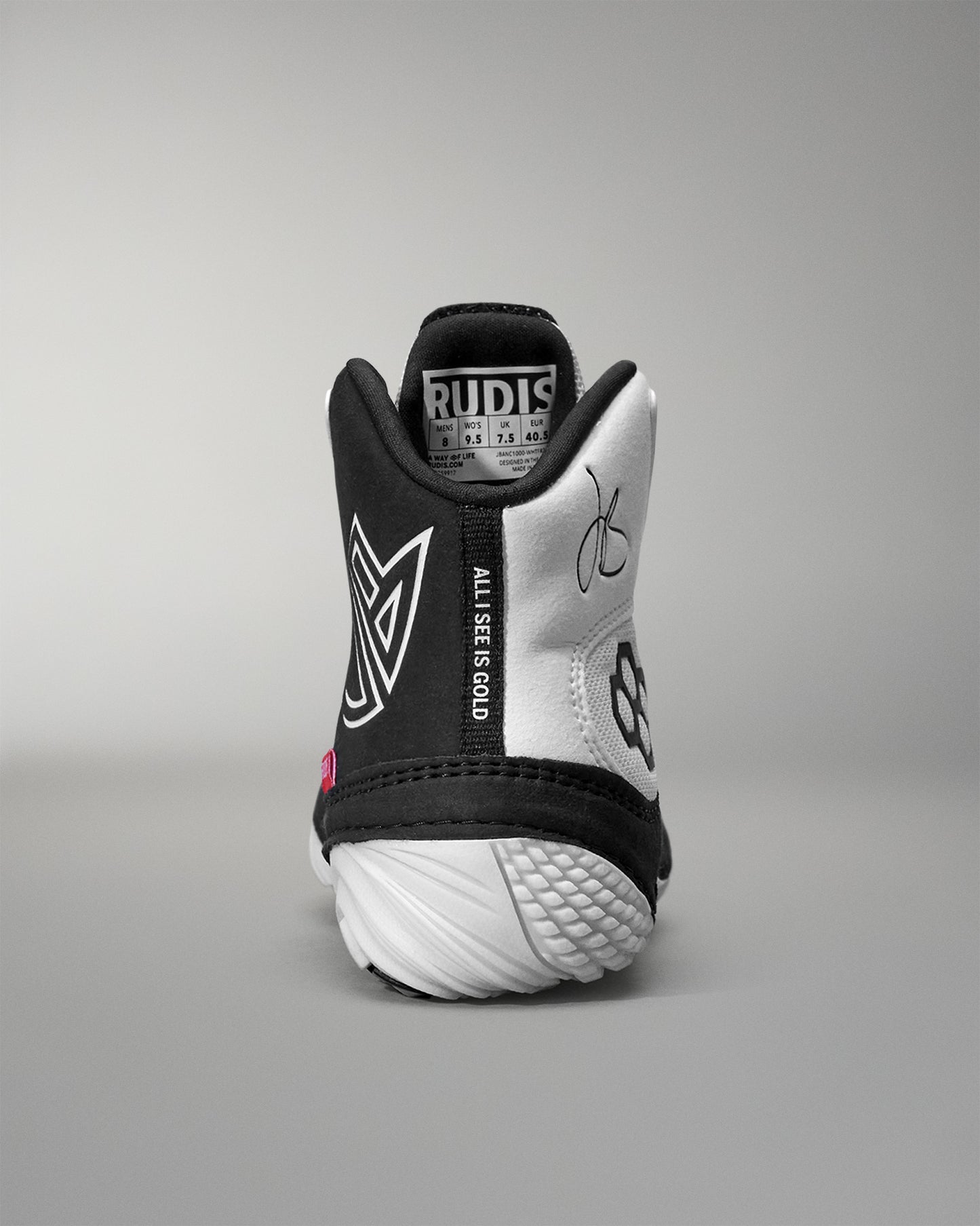 Black and white Jordan Burroughs Wrestling shoes with visible branding on a gray background