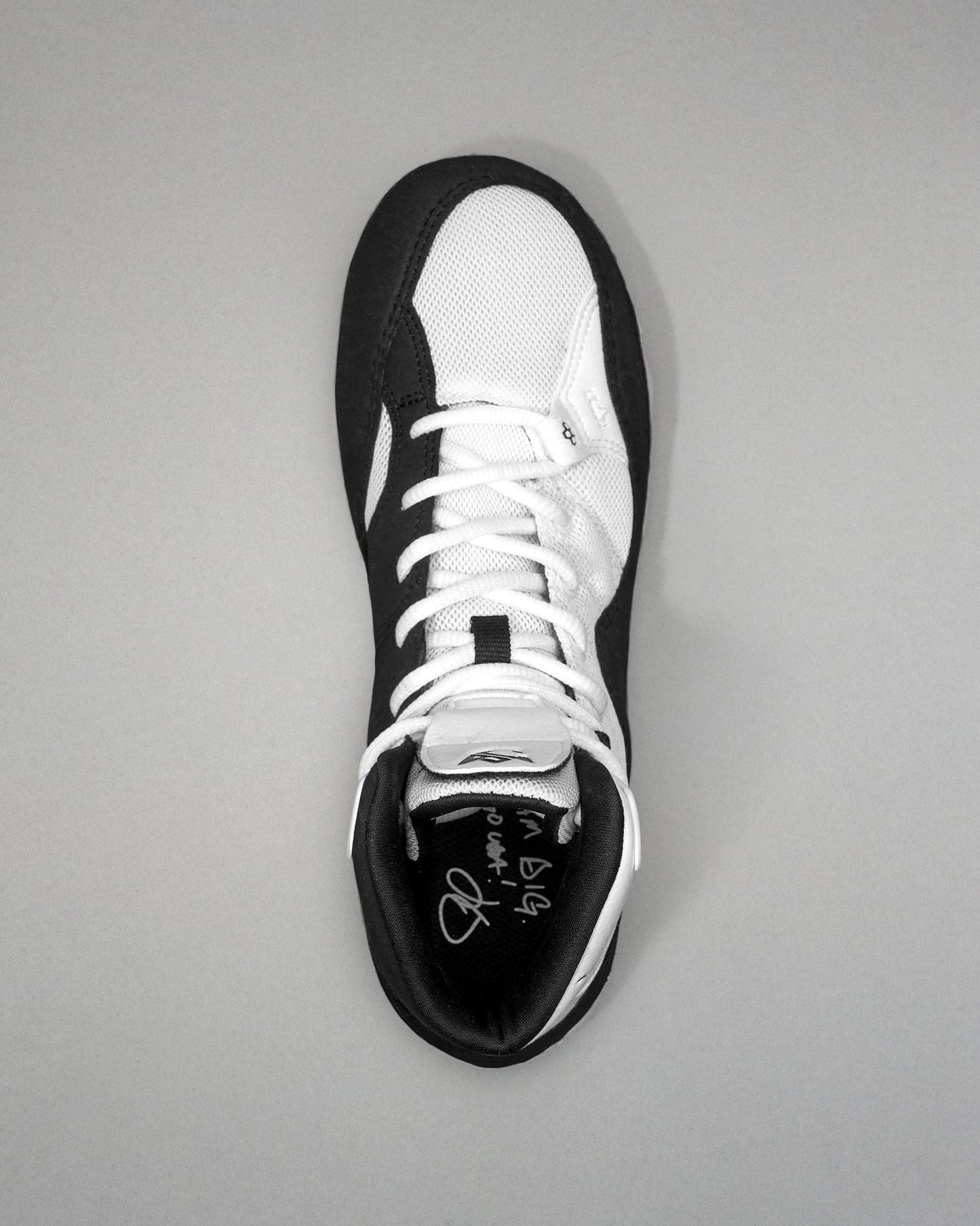 Black and white Jordan Burroughs Wrestling shoes on a gray background
