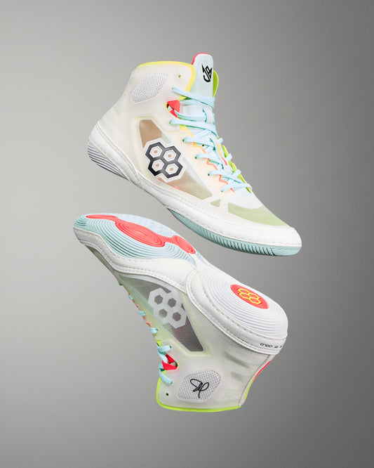 Colorful wrestling shoes with unique design elements on a gray background