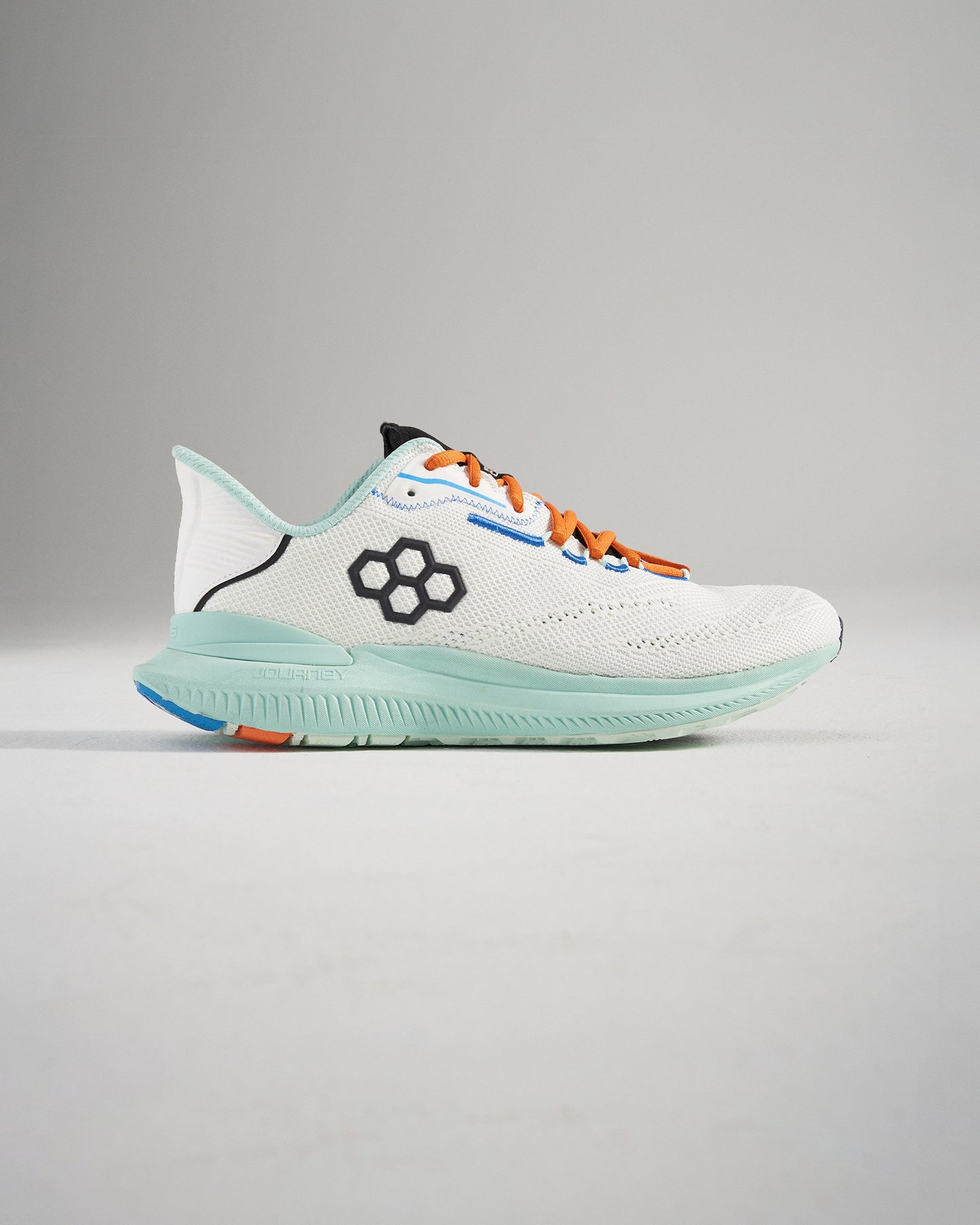 A modern white athletic shoe featuring a breathable mesh upper colorful laces and a vibrant sole with impressive traction