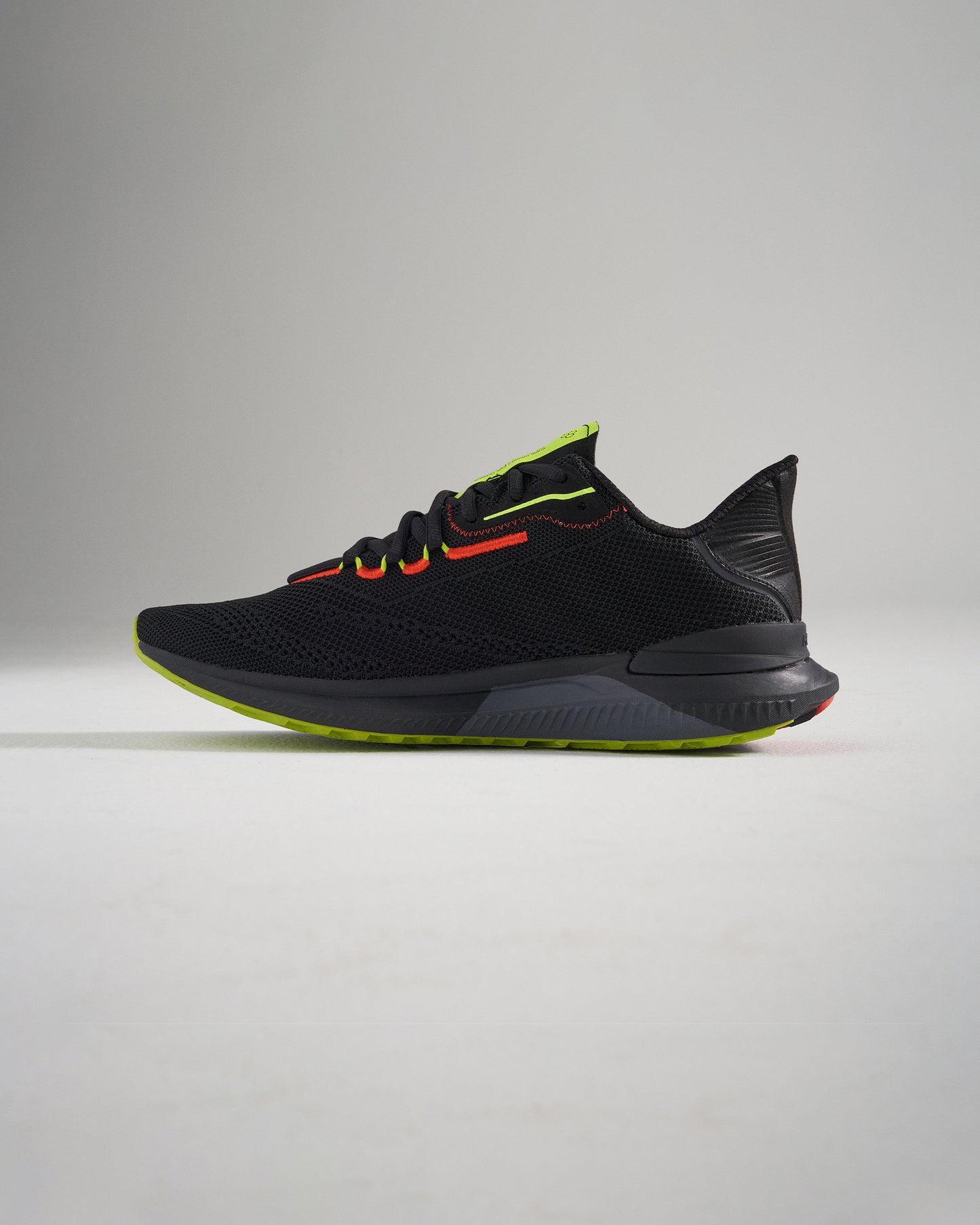 A sleek black running shoe featuring vibrant red and neon yellow accents designed for style and performance