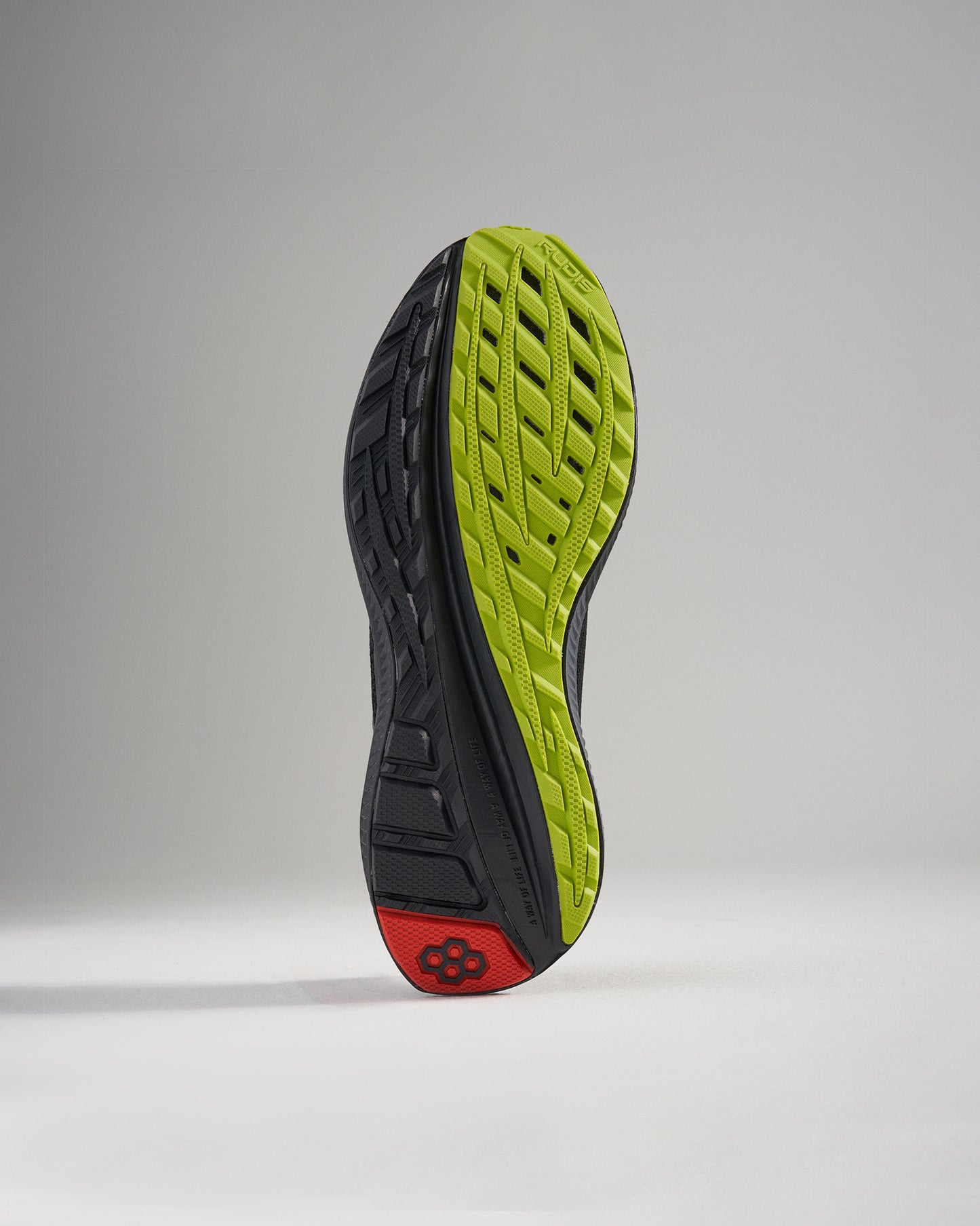 A detailed view of a running shoes sole featuring a sleek design with black and vibrant green colors ideal for showcasing traction and support