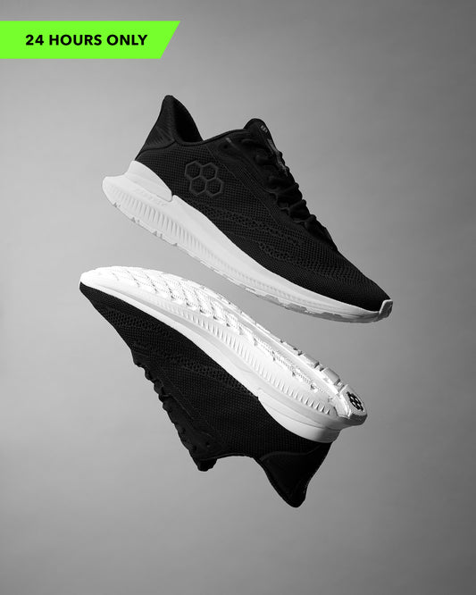 Black and white athletic shoes on a gray background