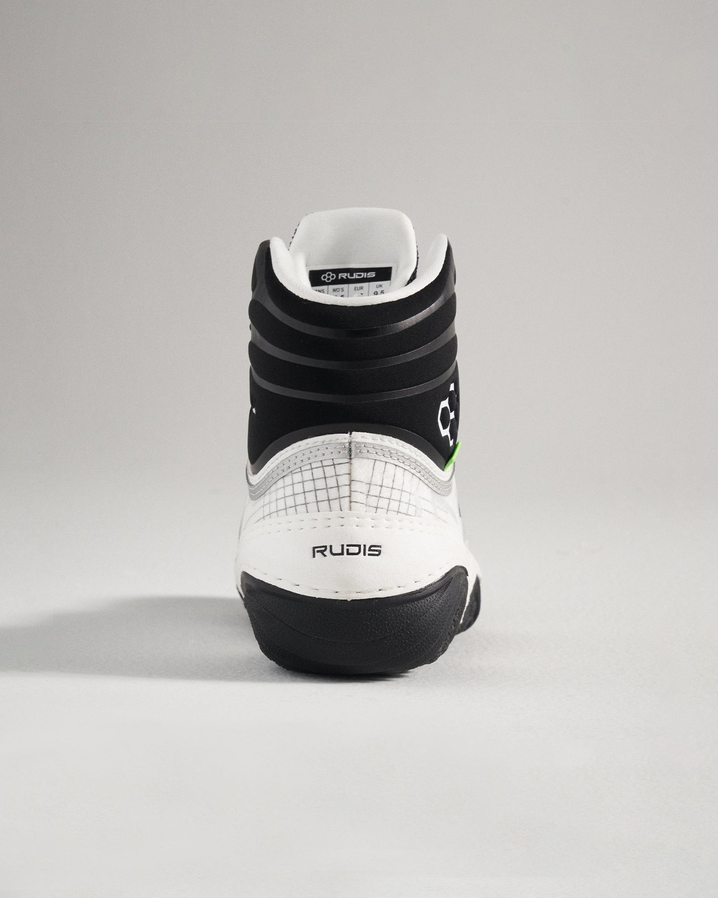 This image displays the back view of a white and black wrestling shoe with detailed design elements and branding