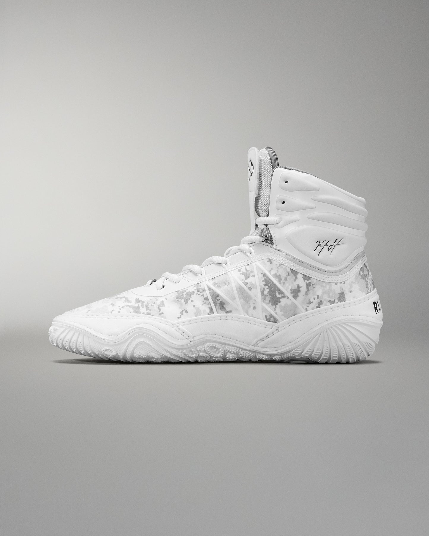 A high-top wrestling shoe in white with a subtle camouflage pattern includes a padded collar and textured sole for grip, suitable for sports activities.