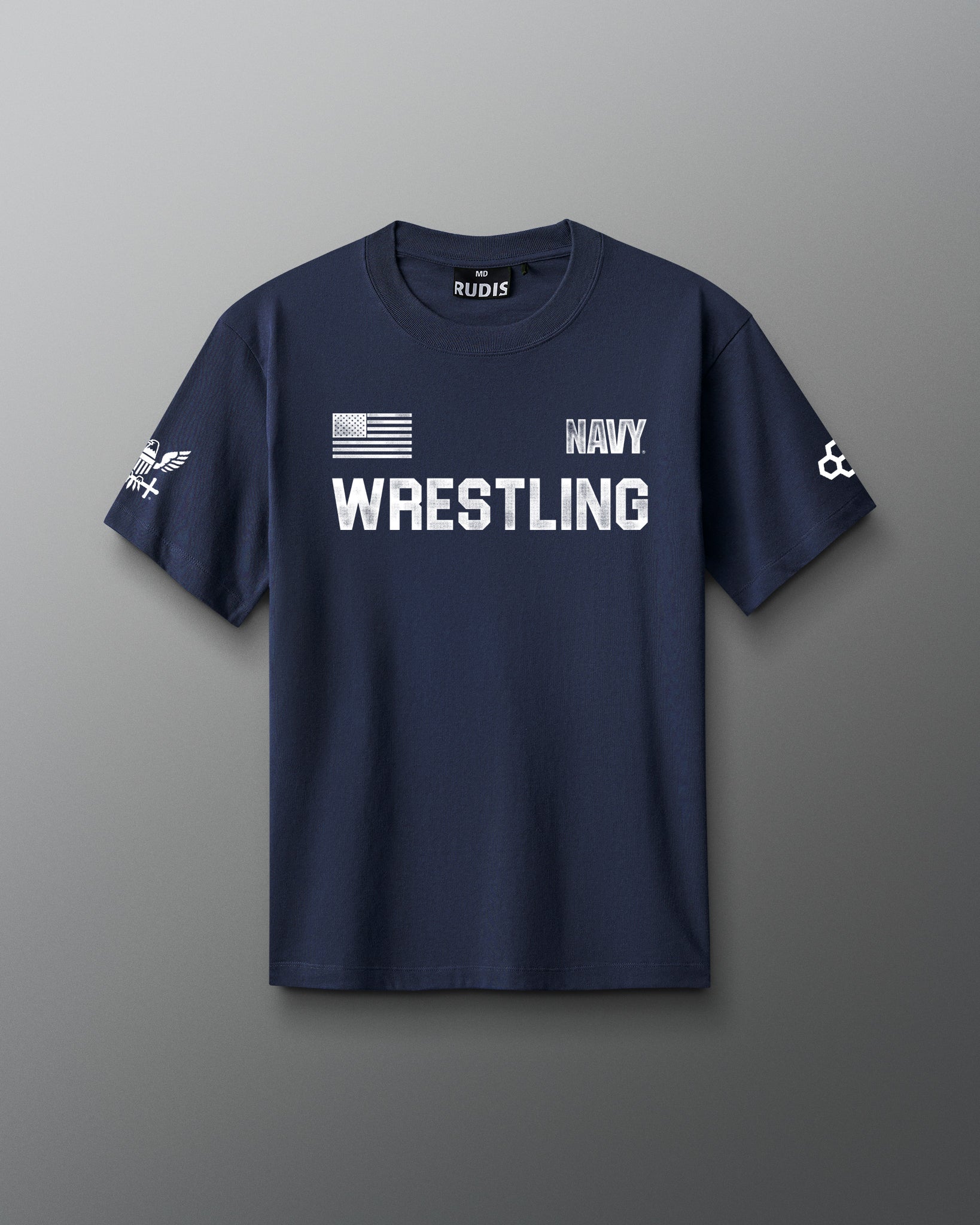 Front view of a navy blue RUDIS T-shirt featuring white text that reads ‘NAVY WRESTLING’ with an American flag graphic, a U.S. Navy insignia on the left sleeve, and a RUDIS hexagon logo on the right sleeve.
