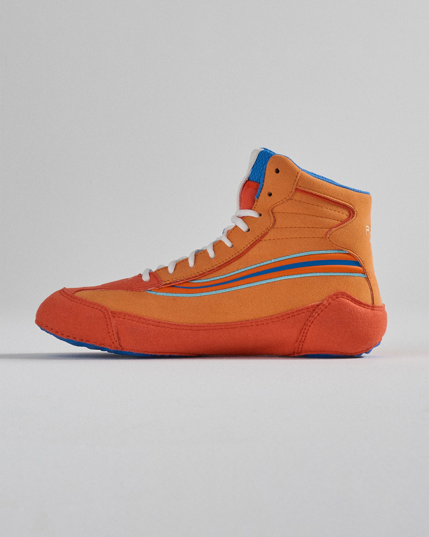 A vibrant orange high-top sneaker with blue and white accents designed for a retro yet modern appeal