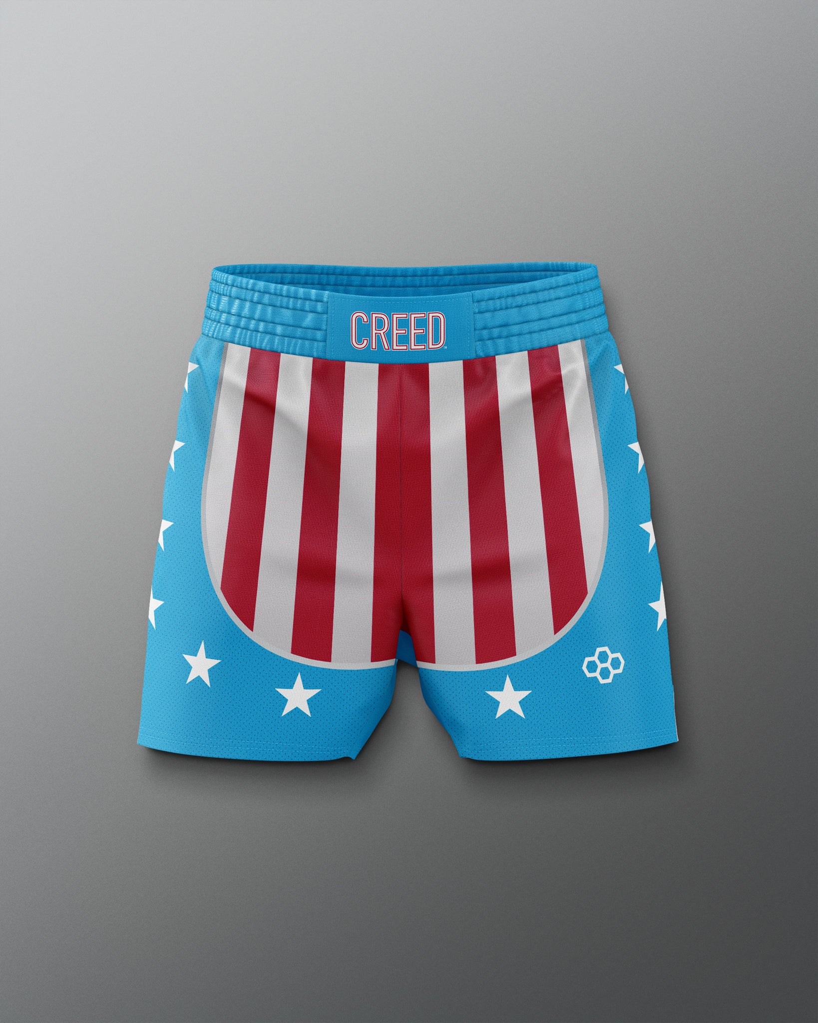 Front view of the Apollo Creed boxing training shorts, featuring red and white vertical stripes on the front, blue sides and waistband with white stars, and 'CREED' text centered on the waistband, inspired by the iconic Rocky movie look.