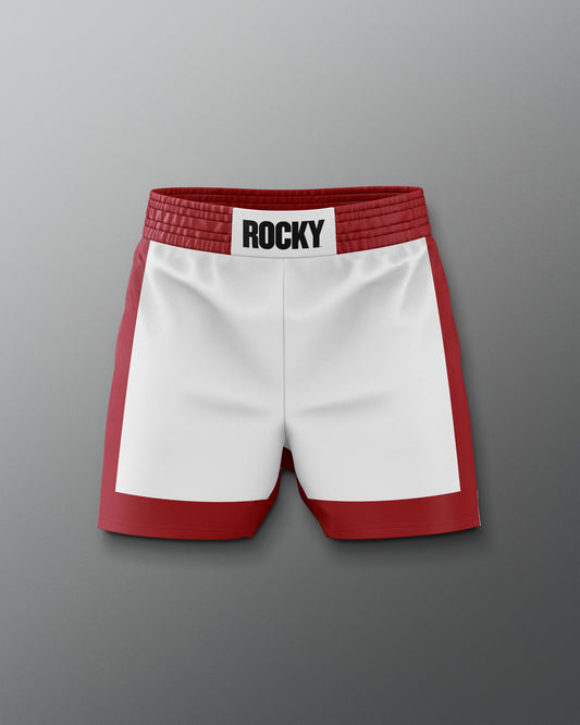 Front view of the ROCKY Balboa Italian Stallion boxing training shorts, featuring a white body with red side panels, a thick red waistband, and a bold 'ROCKY' label centered on the waistband, inspired by the classic Rocky movie look.
