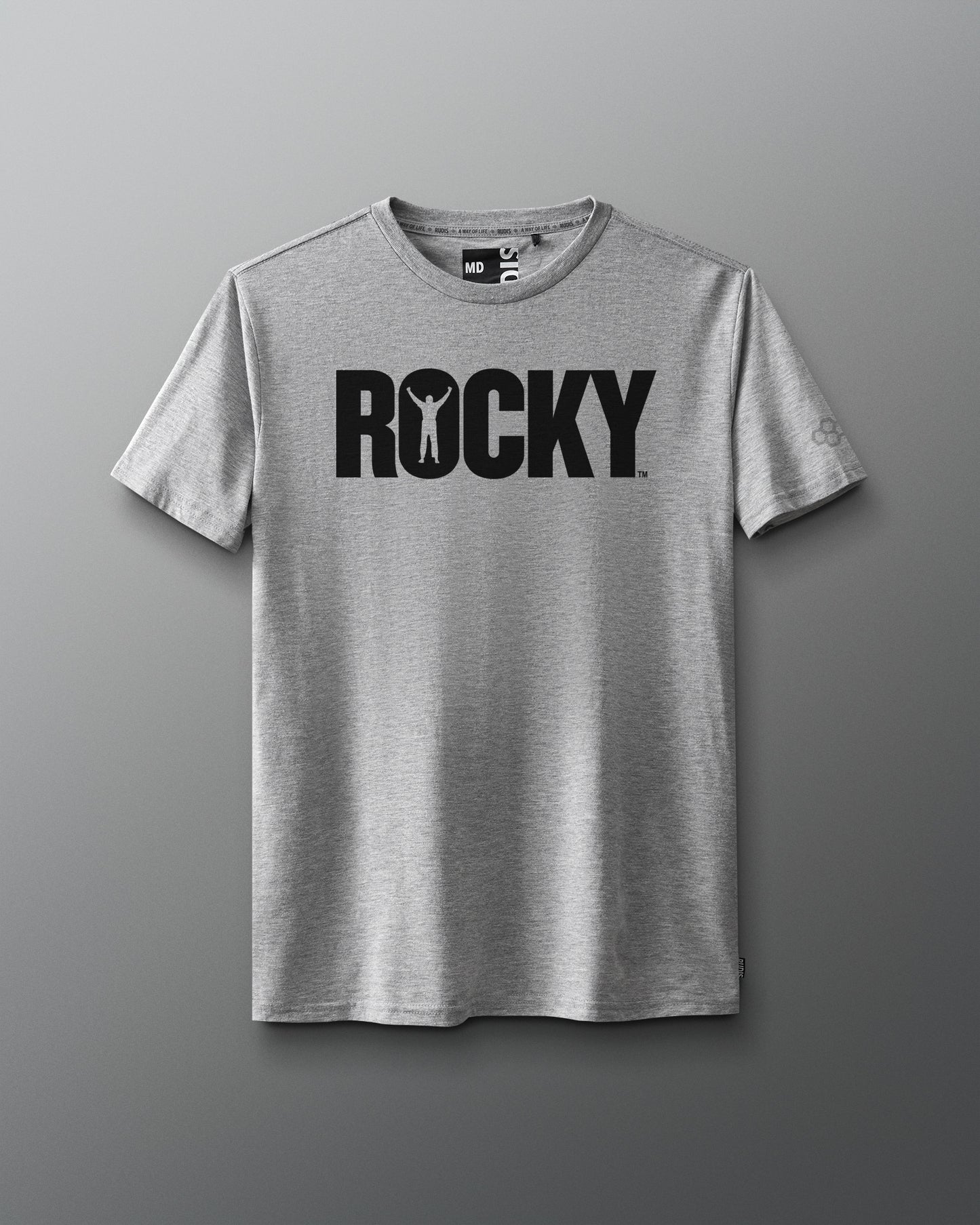 Front view of a gray T-shirt featuring the classic black 'ROCKY' logo across the chest, with the silhouette of a victorious boxer inside the letter 'O,' inspired by the original Rocky movie.