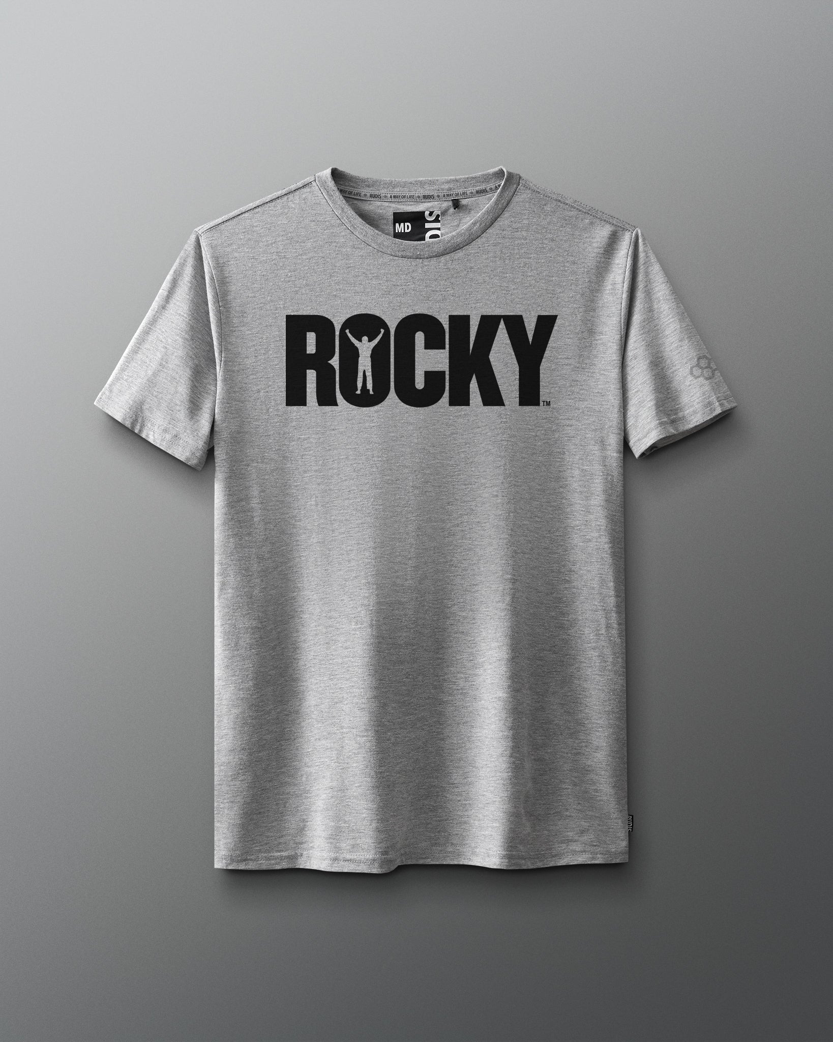 Front view of a gray T-shirt featuring the classic black 'ROCKY' logo across the chest, with the silhouette of a victorious boxer inside the letter 'O,' inspired by the original Rocky movie.