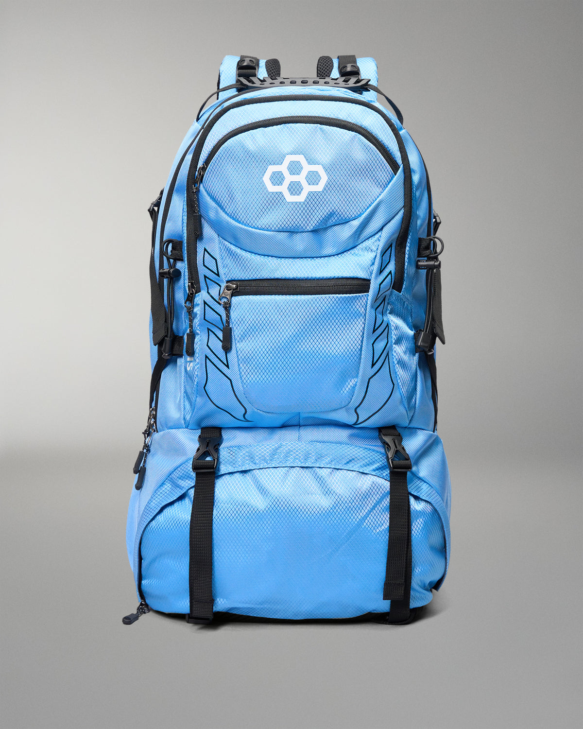 A light blue technical backpack with black straps, zippers, and trim, featuring a white geometric logo on the front pocket, set against a neutral gray background.