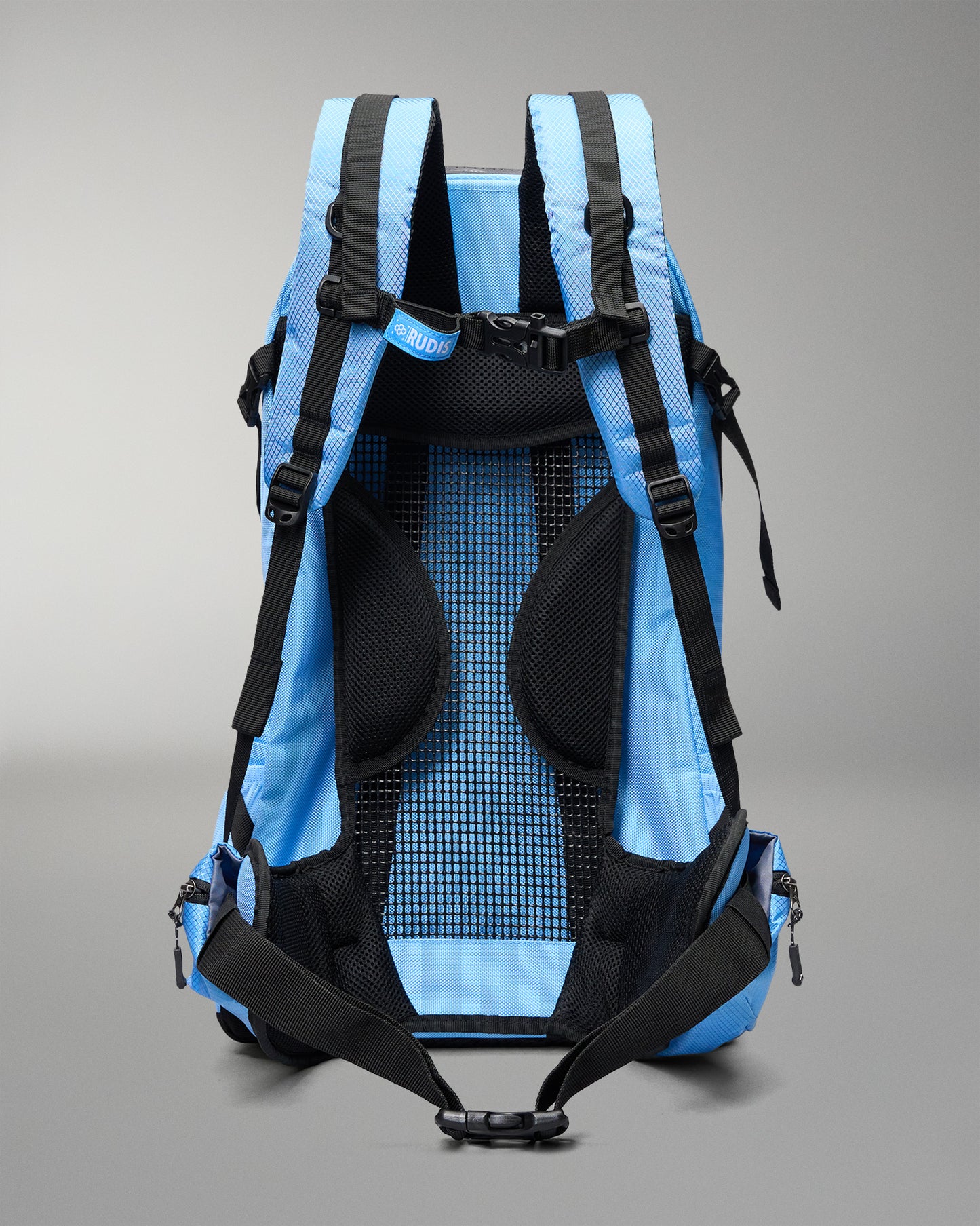 The back view of a light blue and black hiking backpack, showing the padded mesh backrest, shoulder straps, and compression buckles against a neutral gray background.