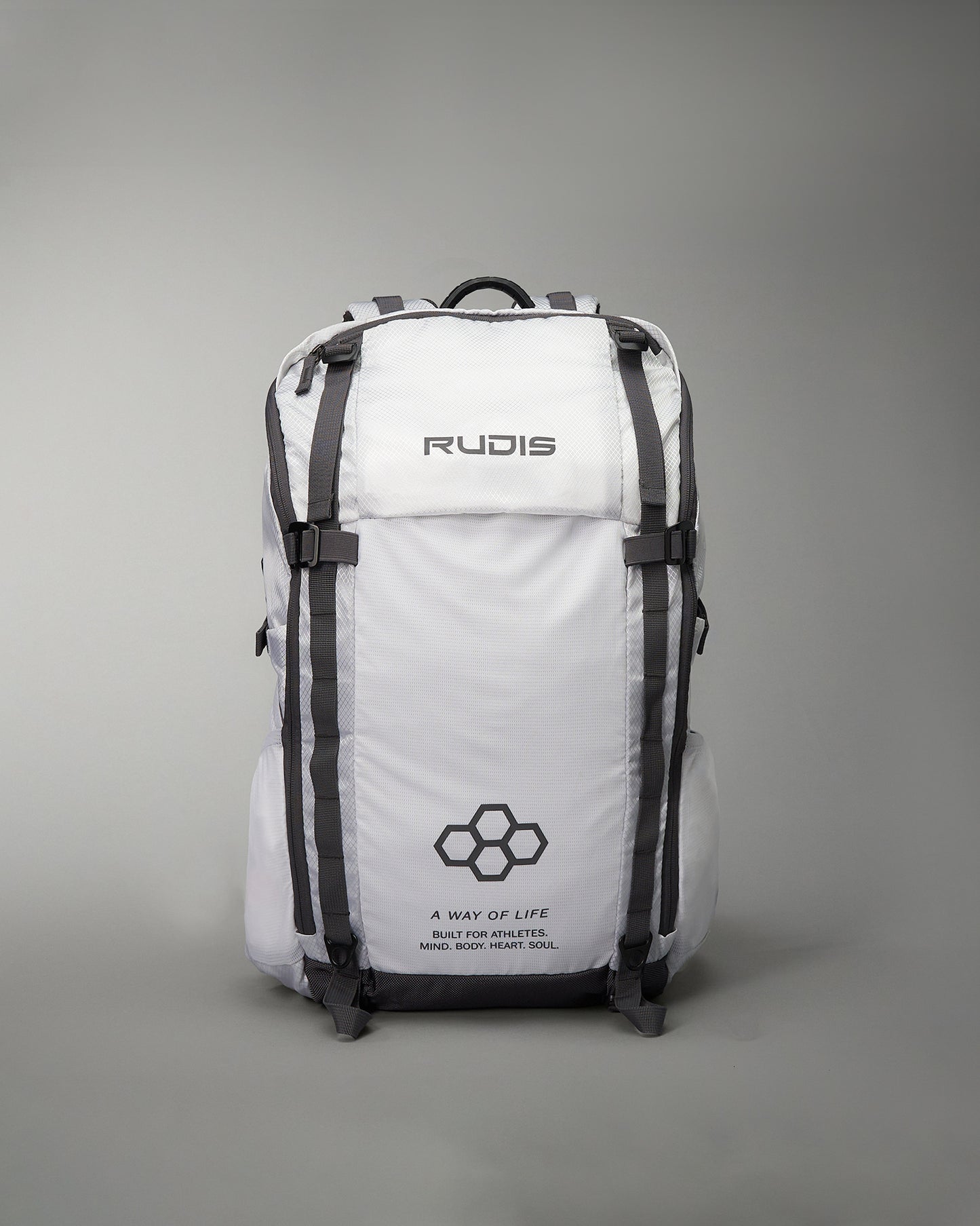 A sleek white backpack designed for athletes featuring the brand name RUDIS prominently displayed and additional motivational text emphasizing a lifestyle built for athletes