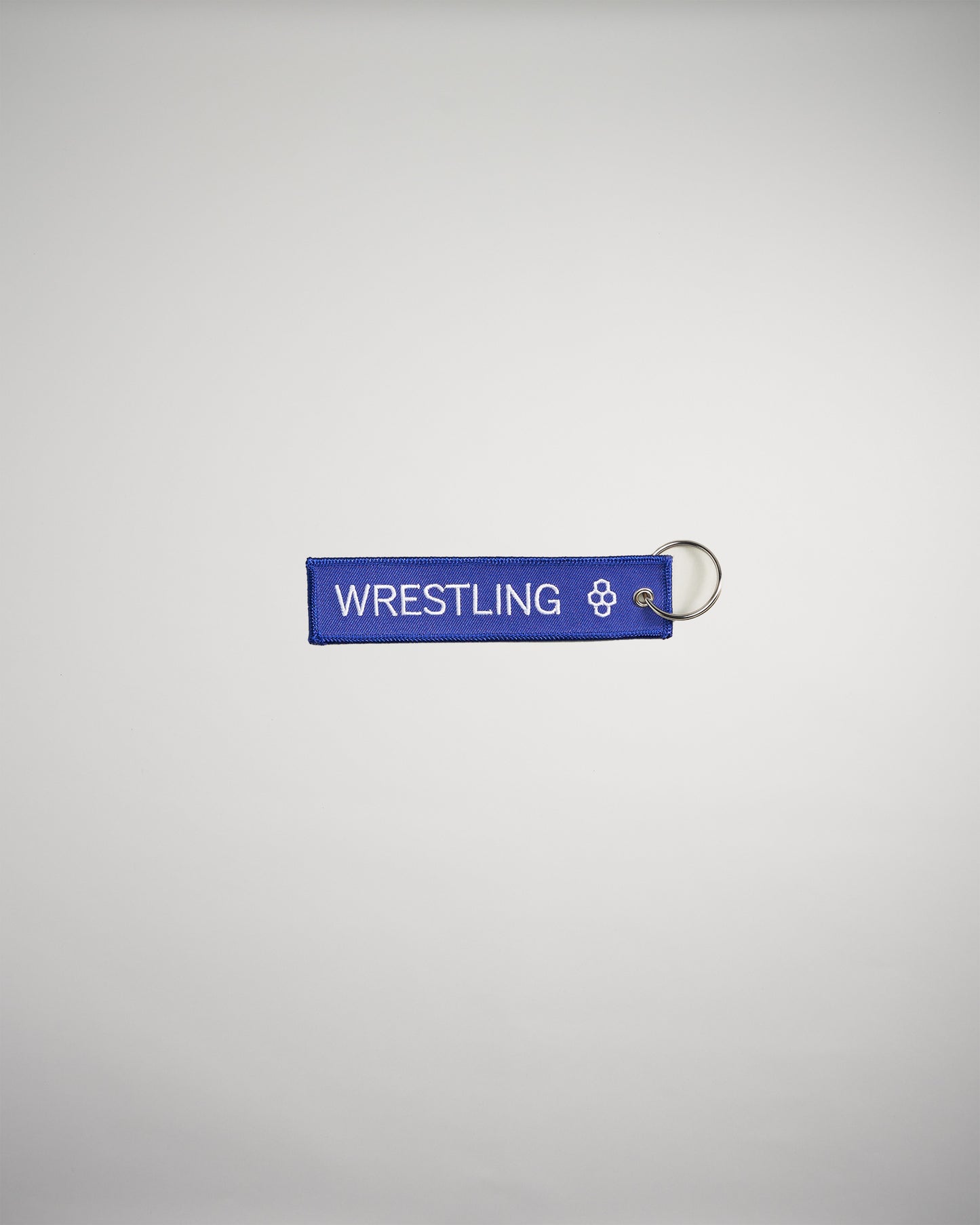 A vibrant blue keychain tag labeled WRESTLING featuring a decorative emblem on one end