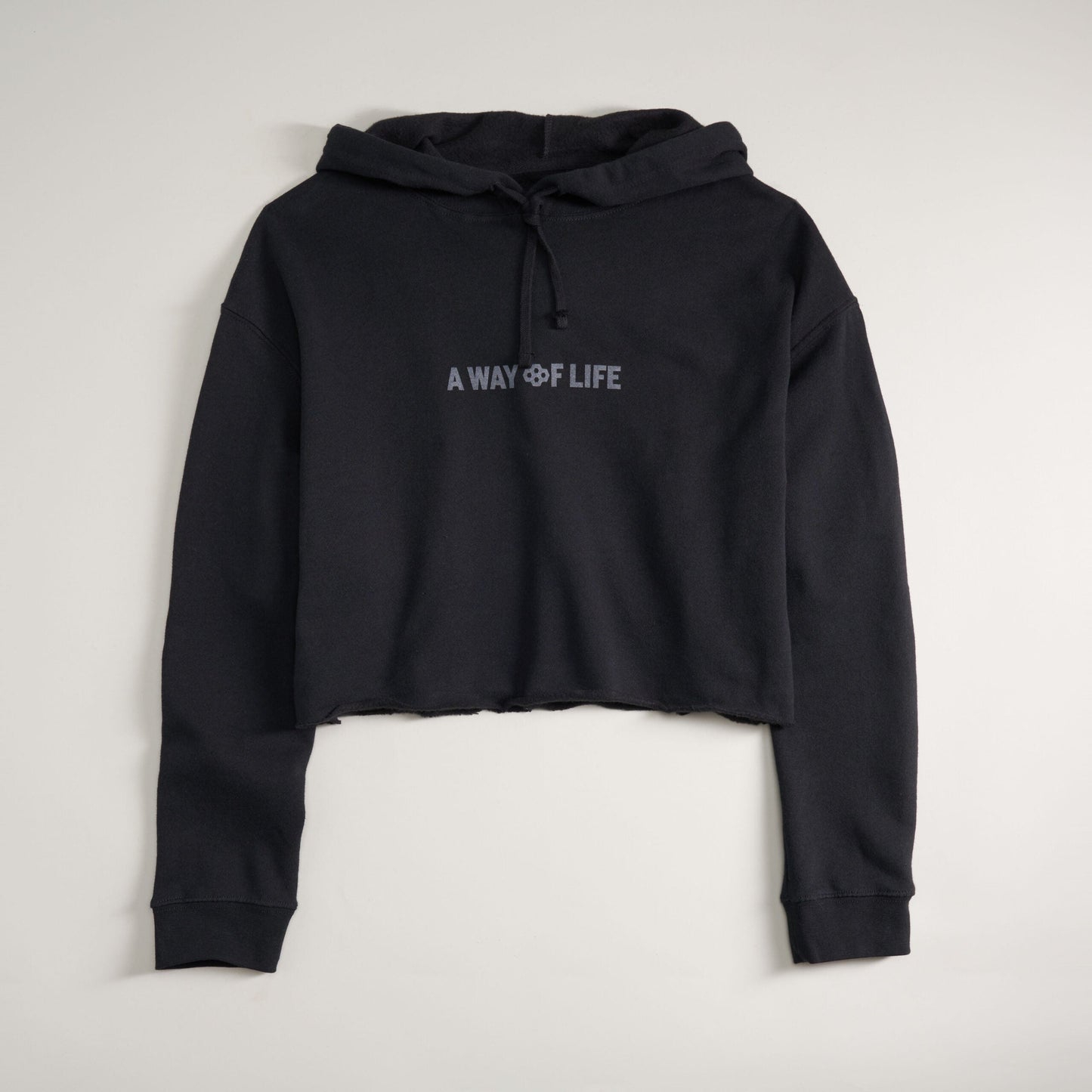 A cropped black hoodie featuring the phrase A WAY OF LIFE in a simple font designed for a casual and stylish look